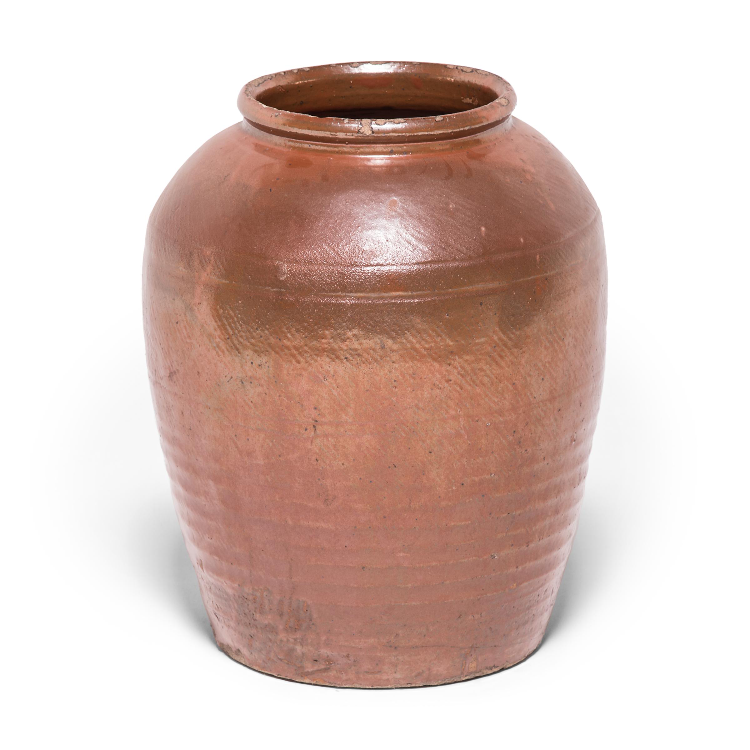 At once ancient and contemporary, this beautiful urn speaks to the timelessness of Chinese ceramic design. Made in northern China in the early 20th century, the urn pays respect to materials and craft, bearing the subtle ribs of its thrown