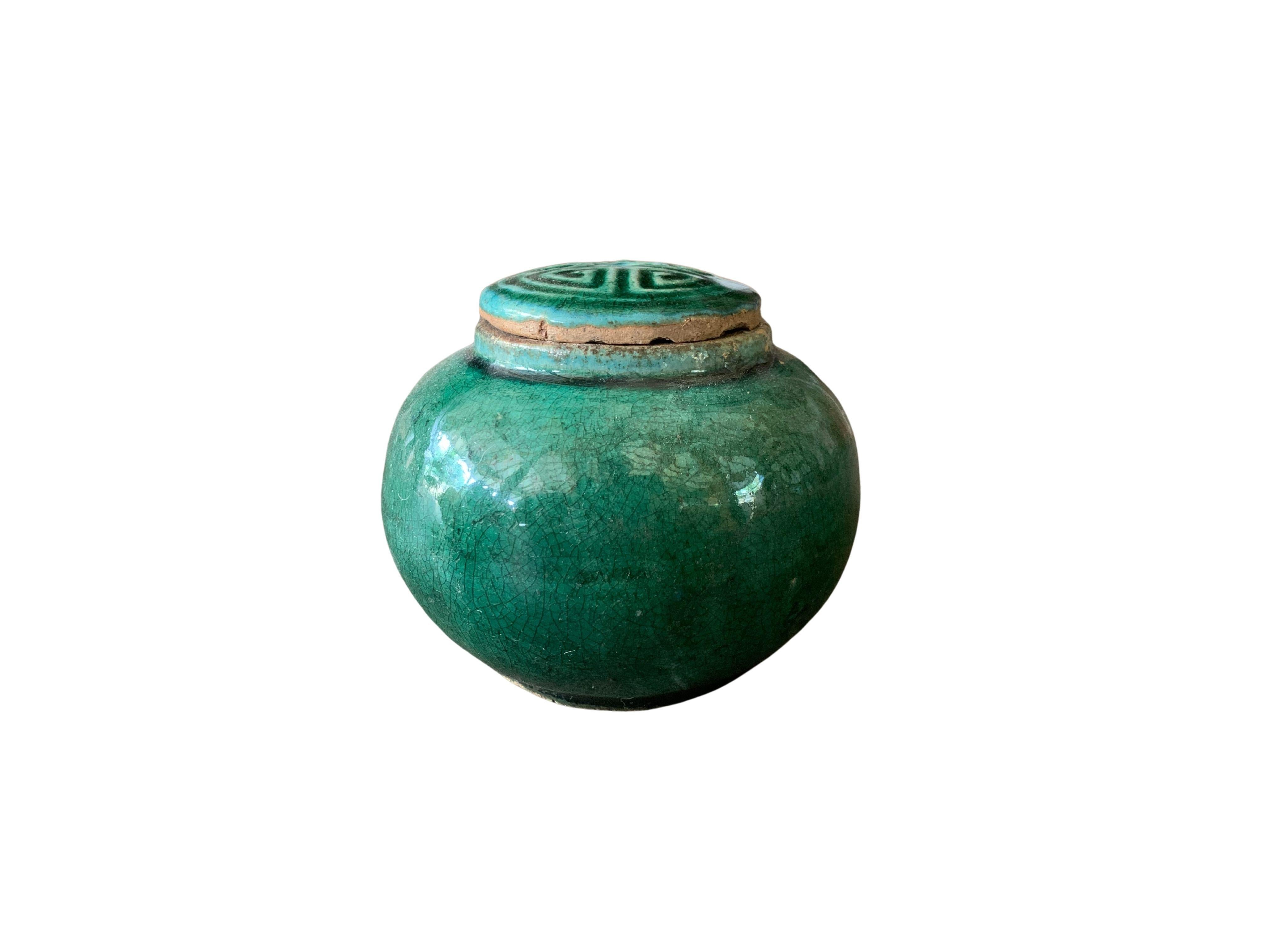 A small early 20th century Shiwan green-glazed ginger jar from China's Shiwanzhen district near Guangdong. It features a beautifully engraved lid.