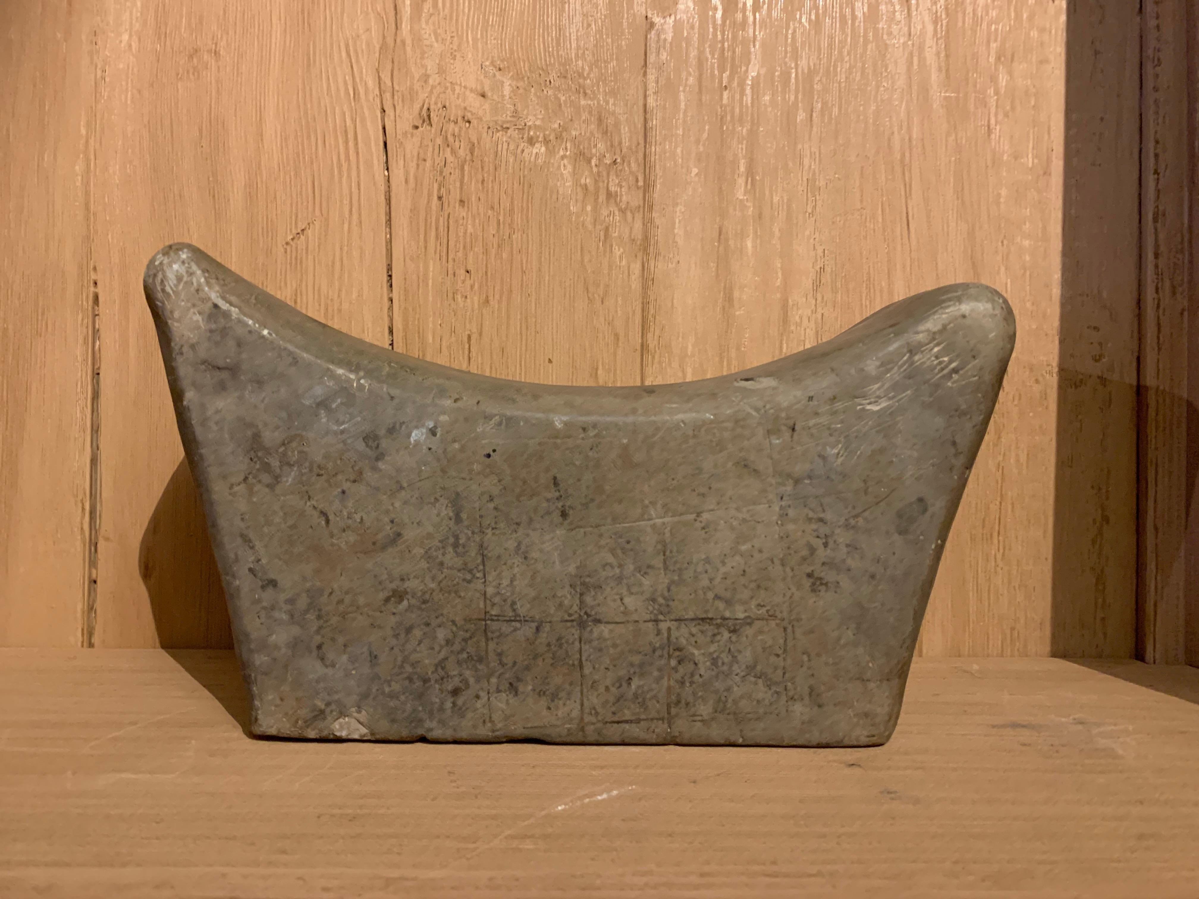 A Chinese unglazed ceramic headrest with lovely patina and naieve carvings on both sides. ONe geometrical and one of a fantasy beast (griffion?). These headrests are found in difformt forms. Sveral cultures (also Europe and US) believed up to the