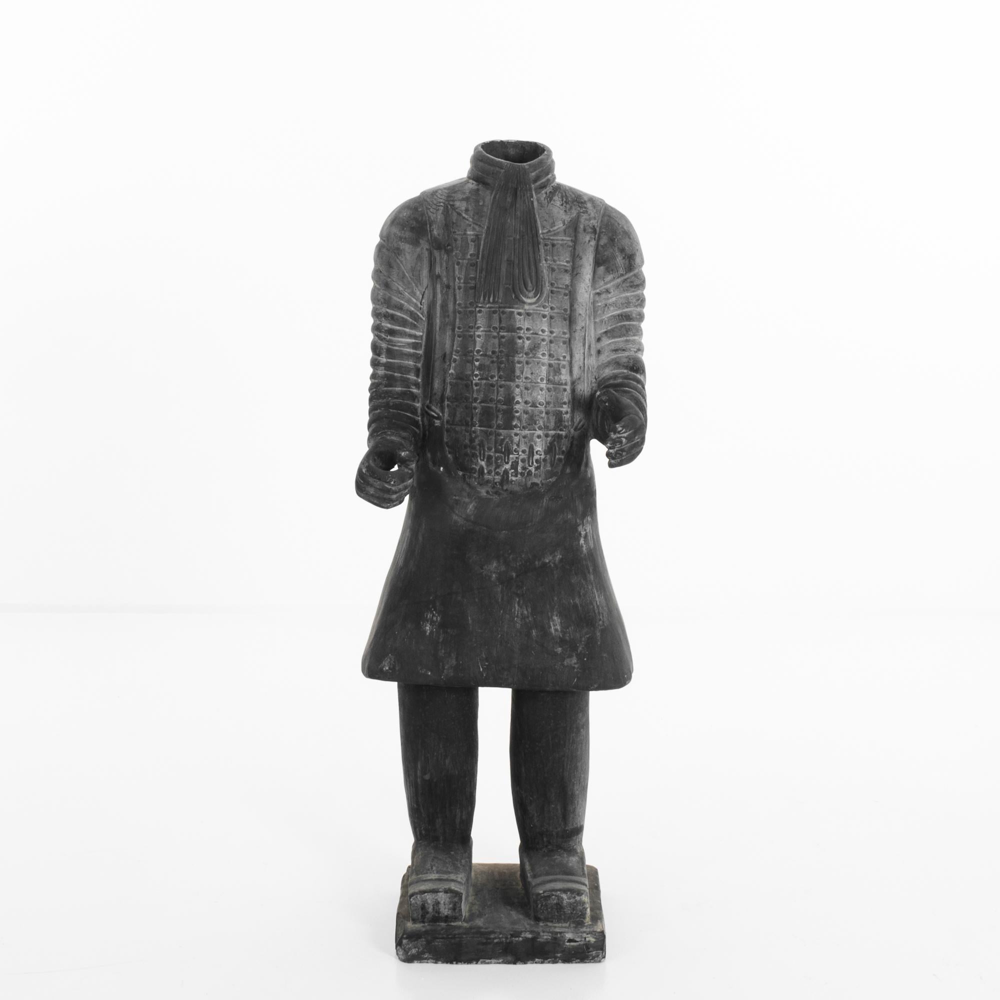 A ceramic sculpture of a soldier produced in China. Around five feet tall, this warrior stands a diligent, silent guard. Similar in style to the Terracotta army of Emperor Qinshihuang, this ceramic soldier stands booted, armored, and scarved on a