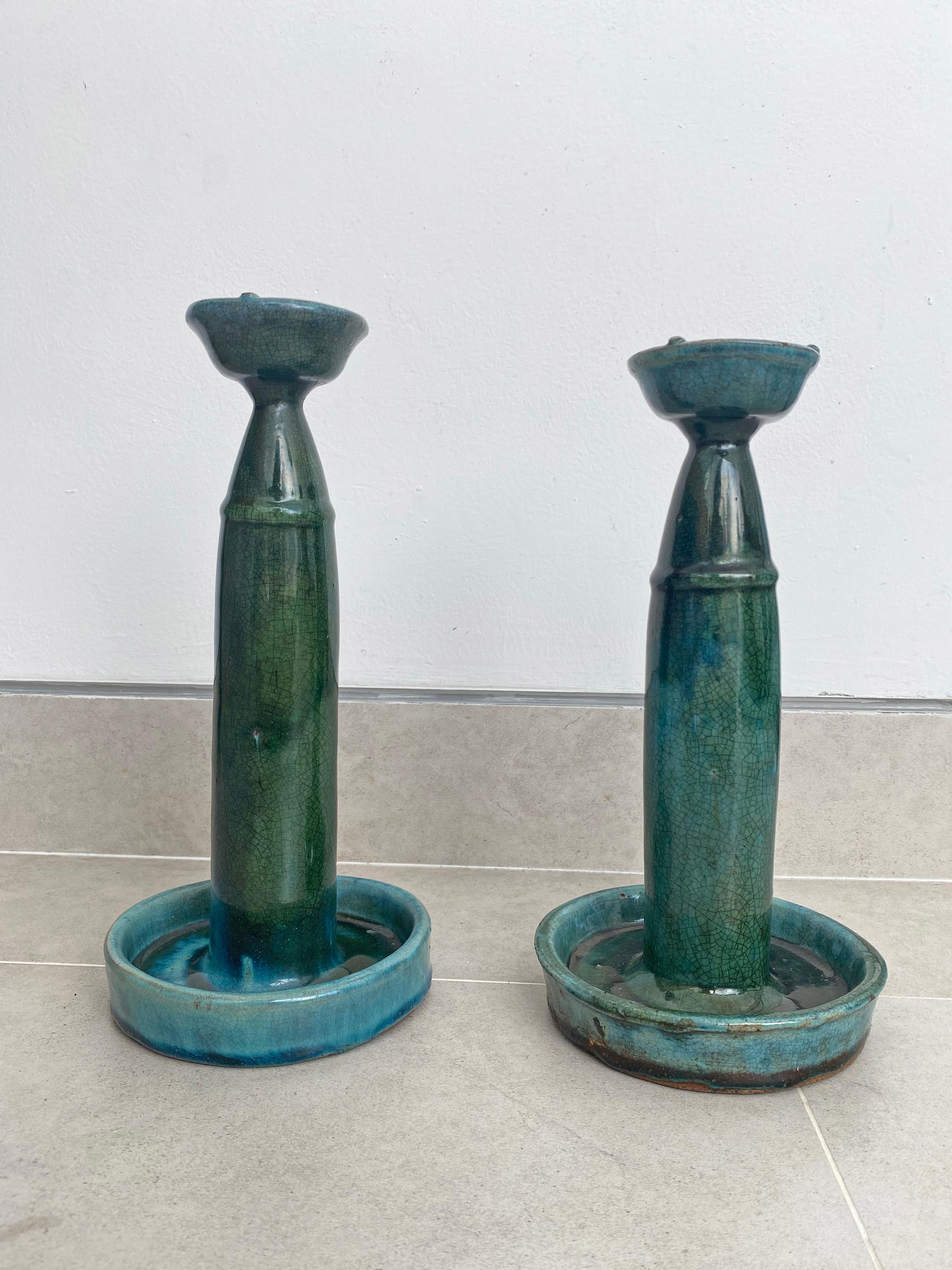 These Shiwan ware oil lamps from the early 20th century feature a green/blue glaze. Shiwan ware is a style of Chinese pottery from the Shiwanzhen district near Guangdong, China. Elegant decorative objects or candleholders. 

Measures: Diameter