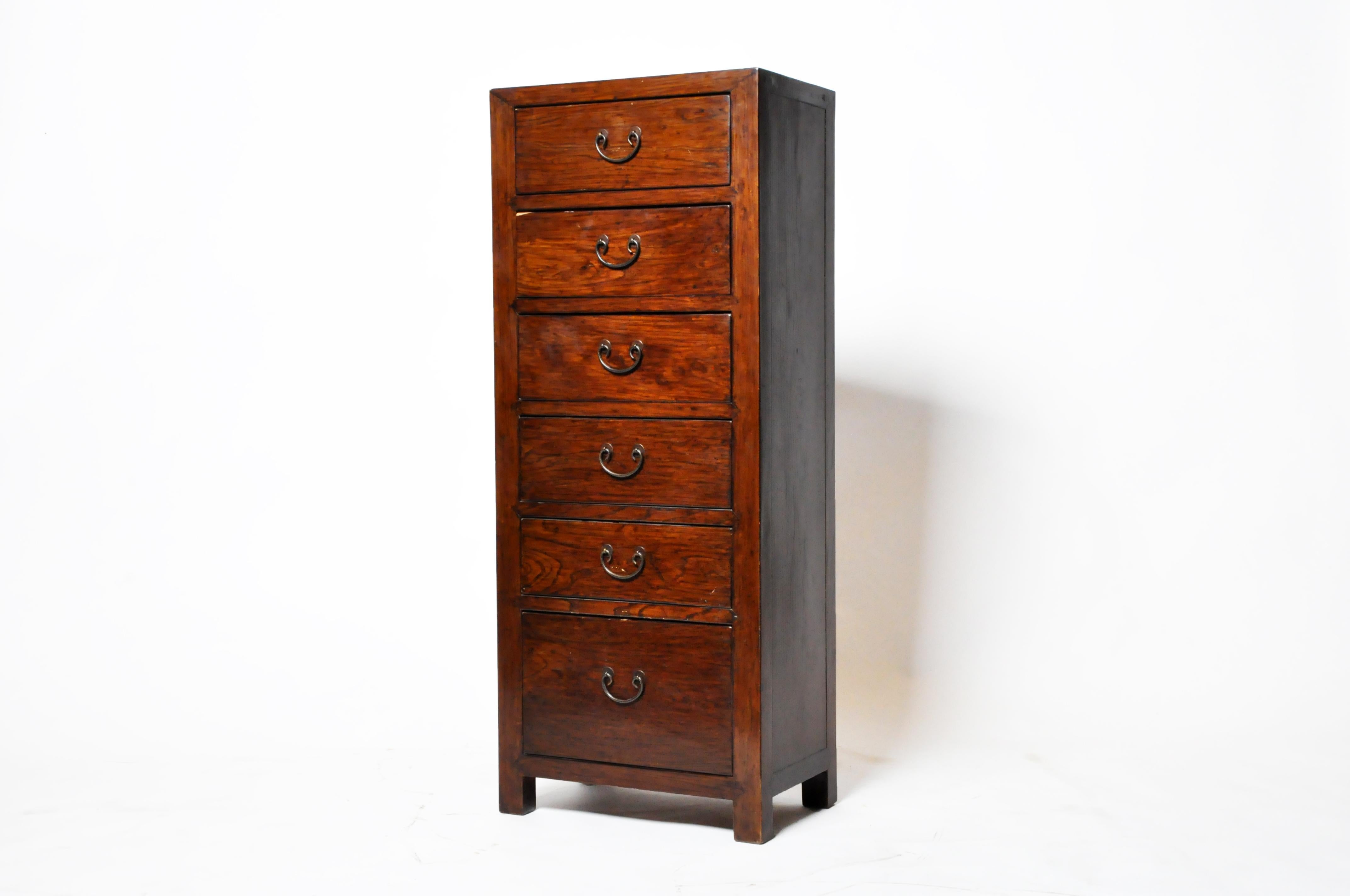 This modern chest of drawers was made from reclaimed elm wood joined in the classic Chinese manner, stained brown, and finished with French Polish (a shellac–based process usually reserved for European antiques). The rich color of the surface is