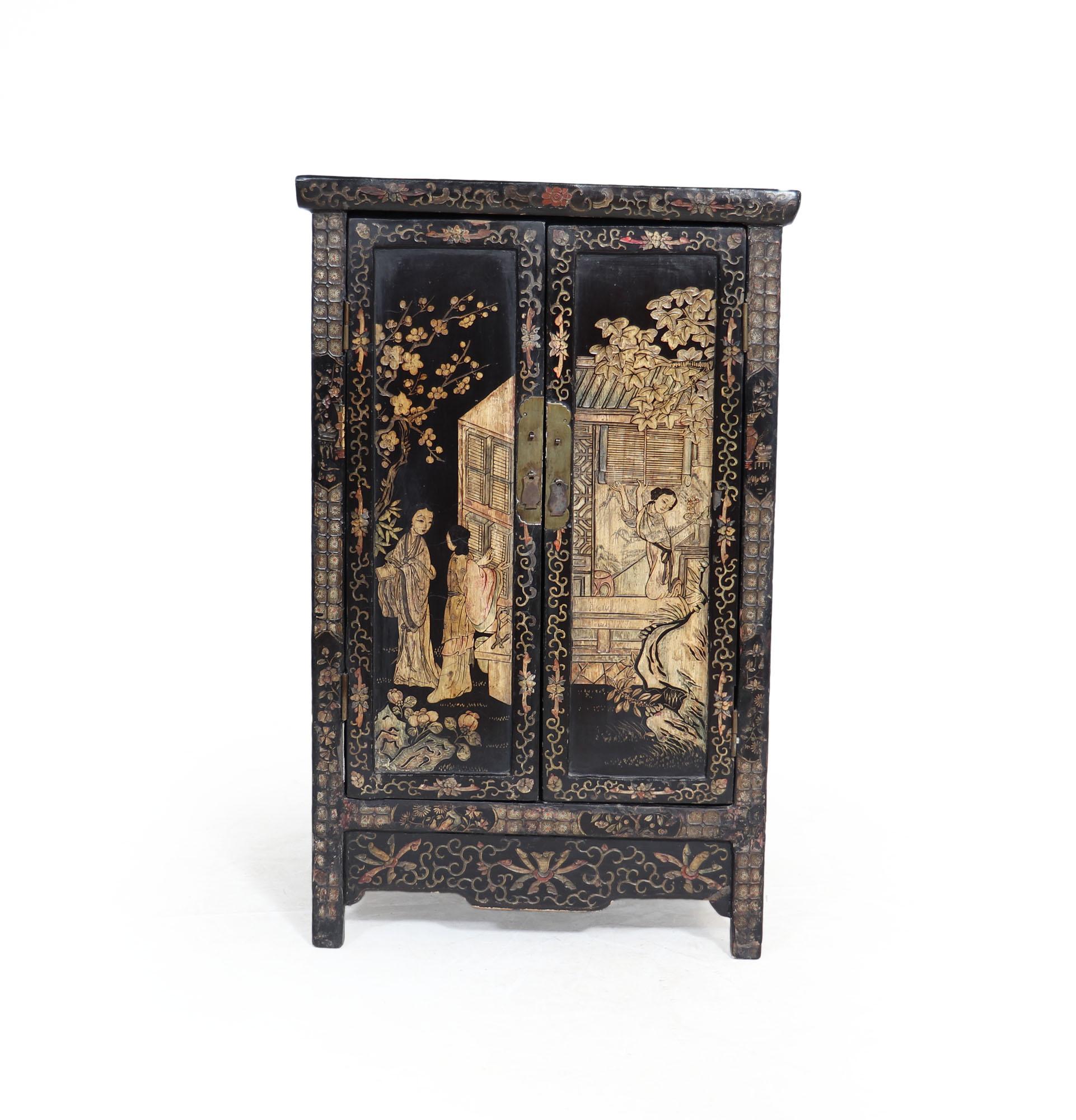 A stunning Chinese Chinoiserie Cabinet from c1860 is an architectural masterpiece. Expertly crafted, the two-door cabinet features intricate metal handles and delicate stone inlay that make it a unique treasure. The cabinet, which is crafted from