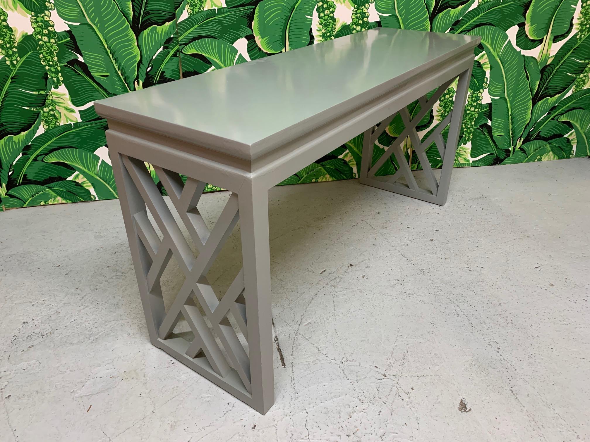 Chinese Chippendale detailing give this glossy gray lacquered console/sofa table the perfect touch of chinoiserie. Very good condition with only very minor imperfections consistent with age.