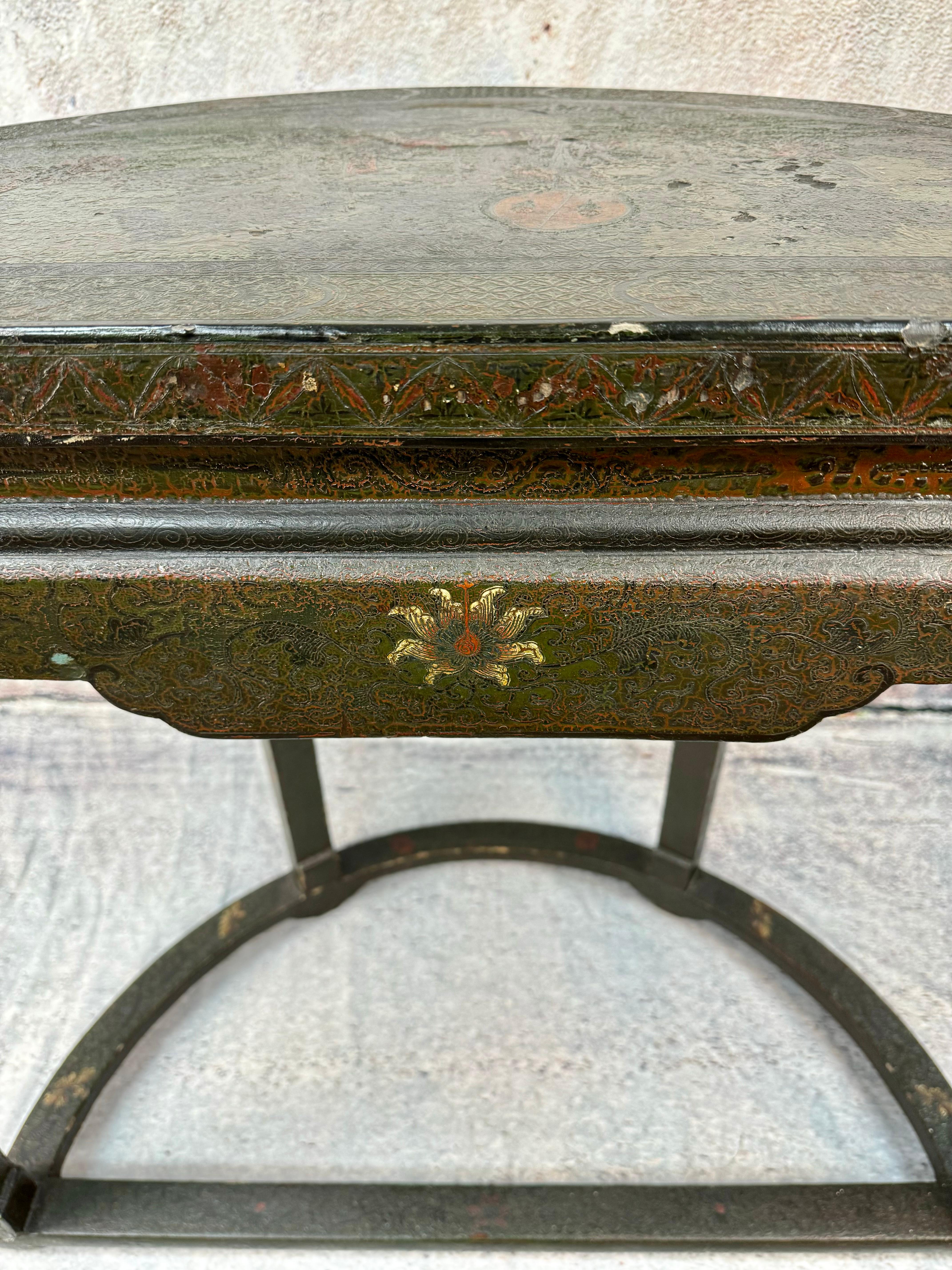 19th Century Chinese Chinoiserie Demilune Console Table with hand-painted Asian scenes including trees, foliage, flowers and Chinese characters. Colors include black, green and red. Scroll work on upper legs. 