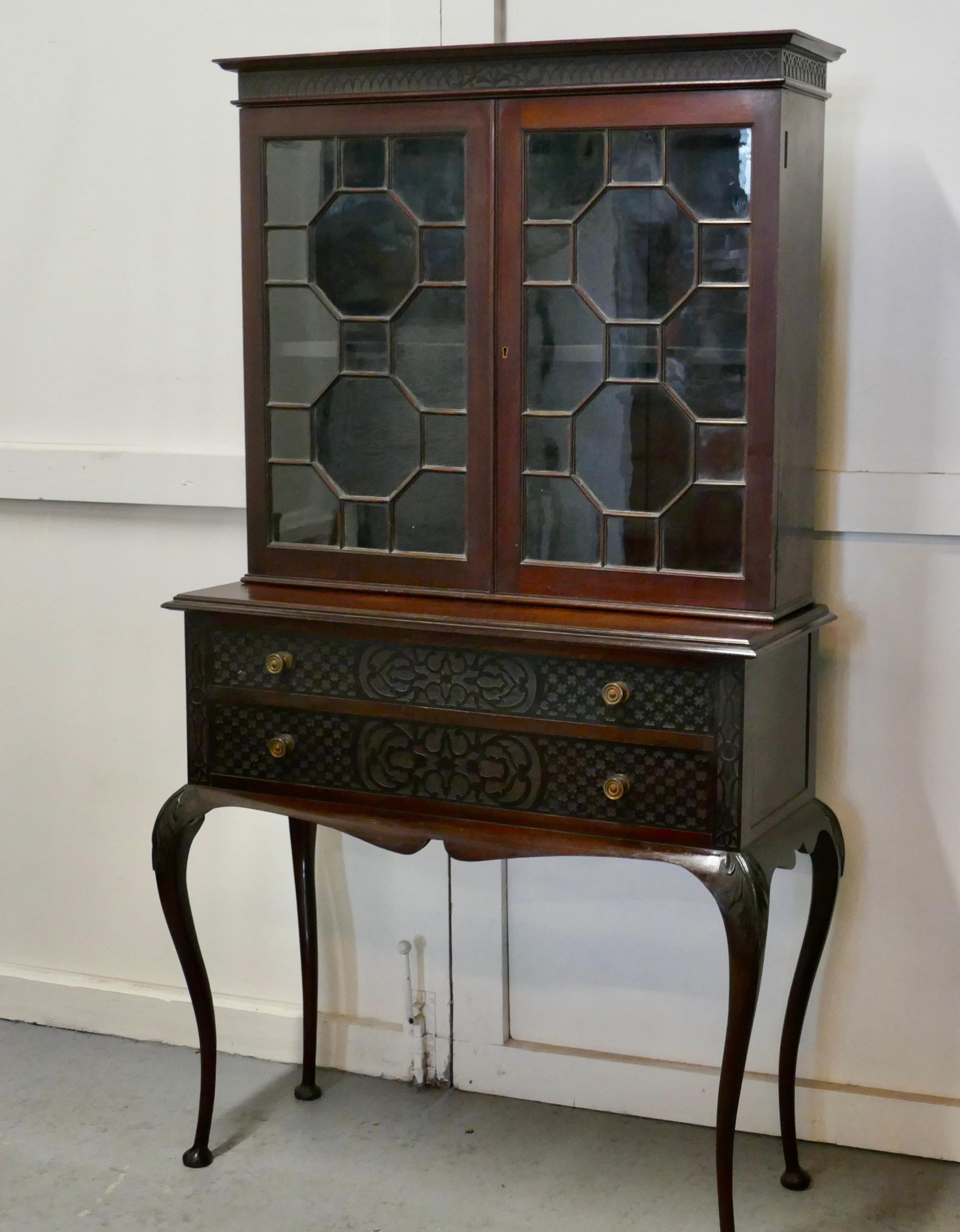 Chinese Chippendale astral glazed display cabinet

This is a very attractive piece, it is made in mahogany, the cabinet has 2 astral glazed doors and is shelved inside
The base of the cabinet has 2 long drawers with brass handles and it stand on