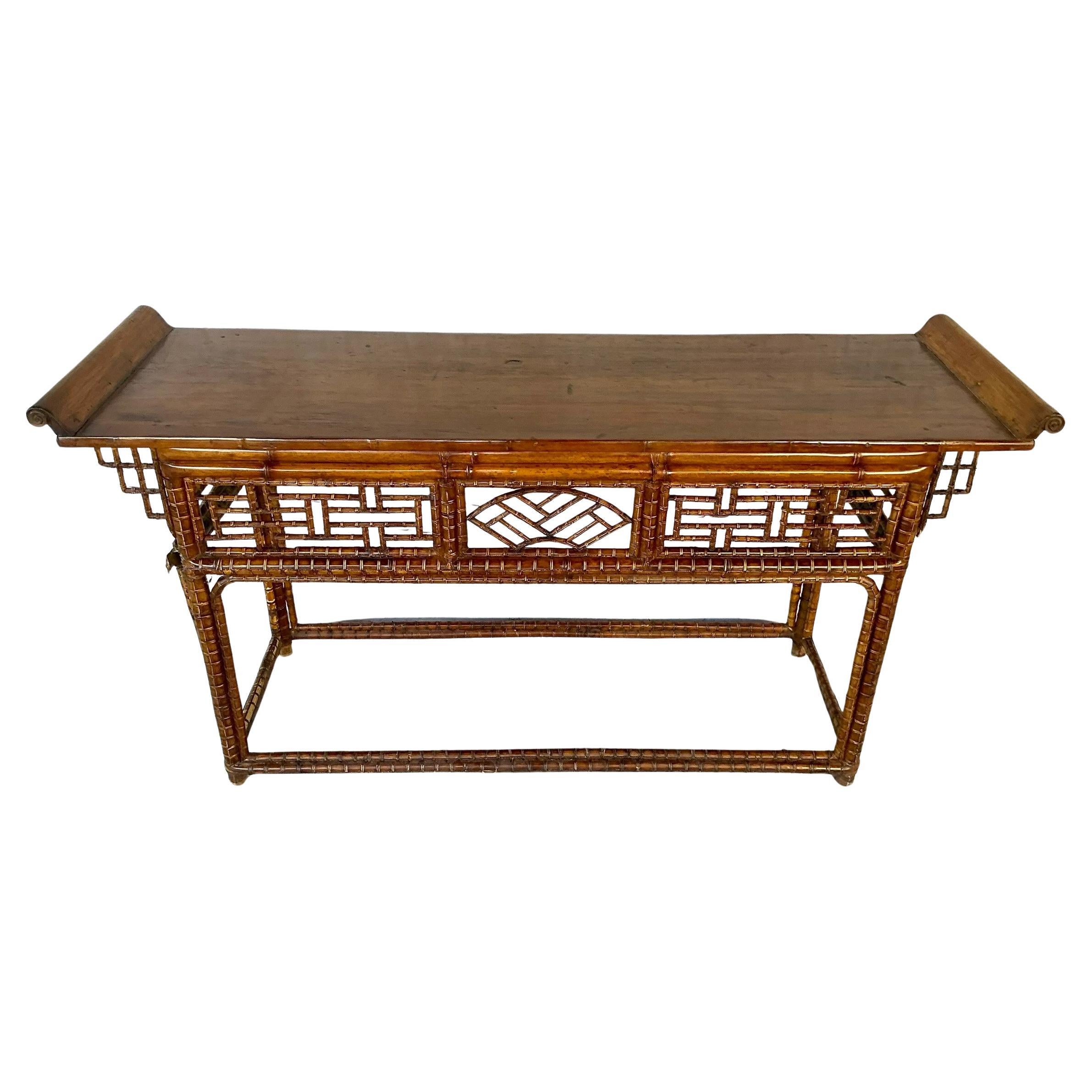 Large Chinese Export Console in Bamboo, Chinese Chippendale Style, known for its blend of Eastern latticework and Western decorative sensibilities. The table features a patinated bamboo frame with intricately woven geometric fretwork panels along
