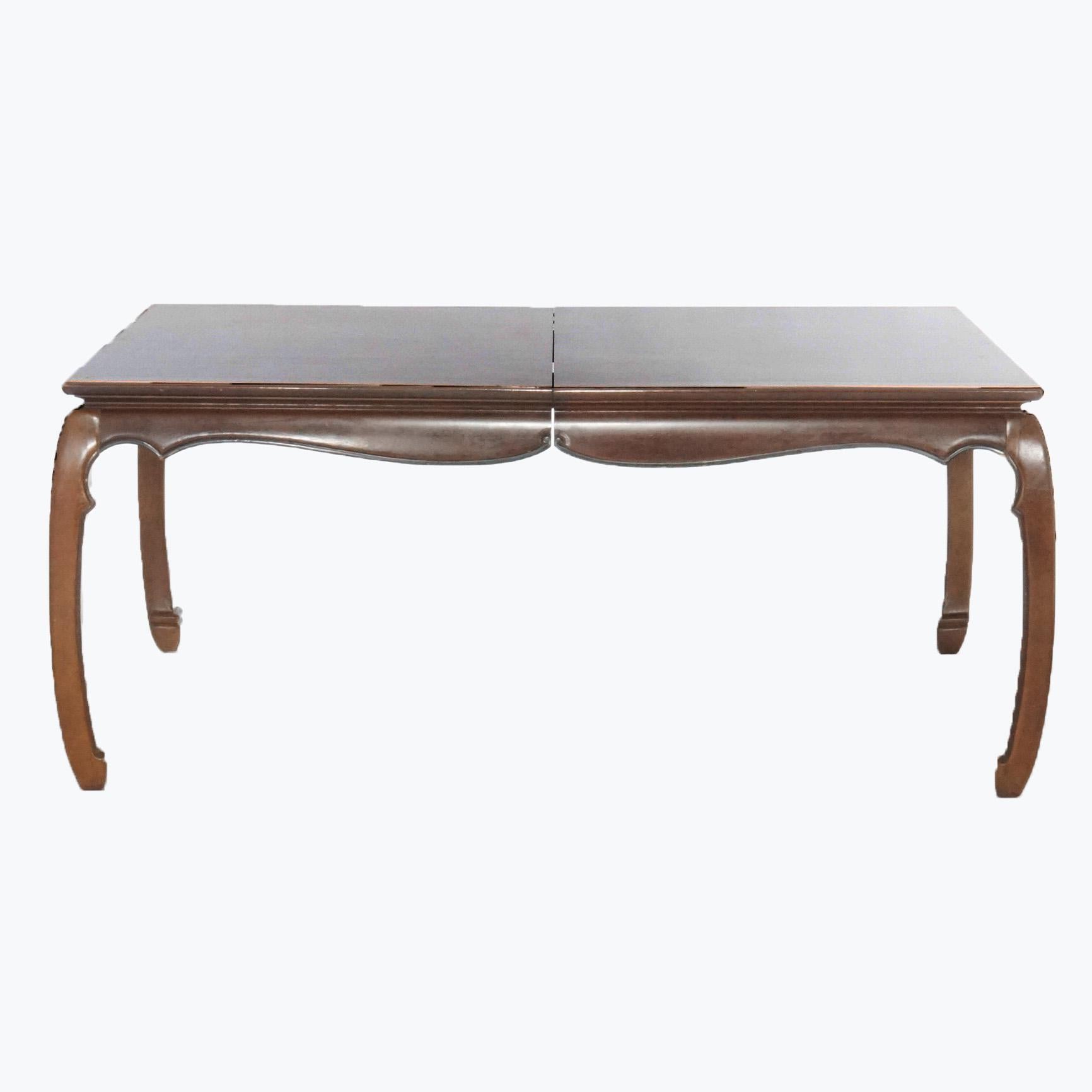 A Chinese Chippendale style dining table offers mahogany construction with burl inset top over shaped skirt and raised on bowed legs, 20th century

Measures- 30.25'' H x 45.25'' W x 70'' D.