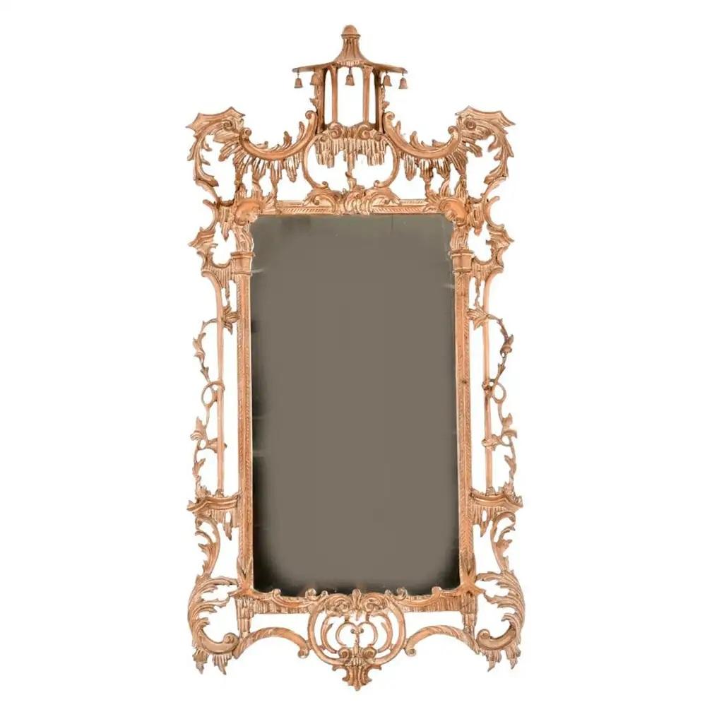 George III Style Chinese Chippendale Carved Wood Pagoda Mirror. Mirror features hand carved cerused pine surface. Intricate carving on frame features acanthus leaves, pagoda top, and bells. This is an eye-catching, opulent piece and would be a