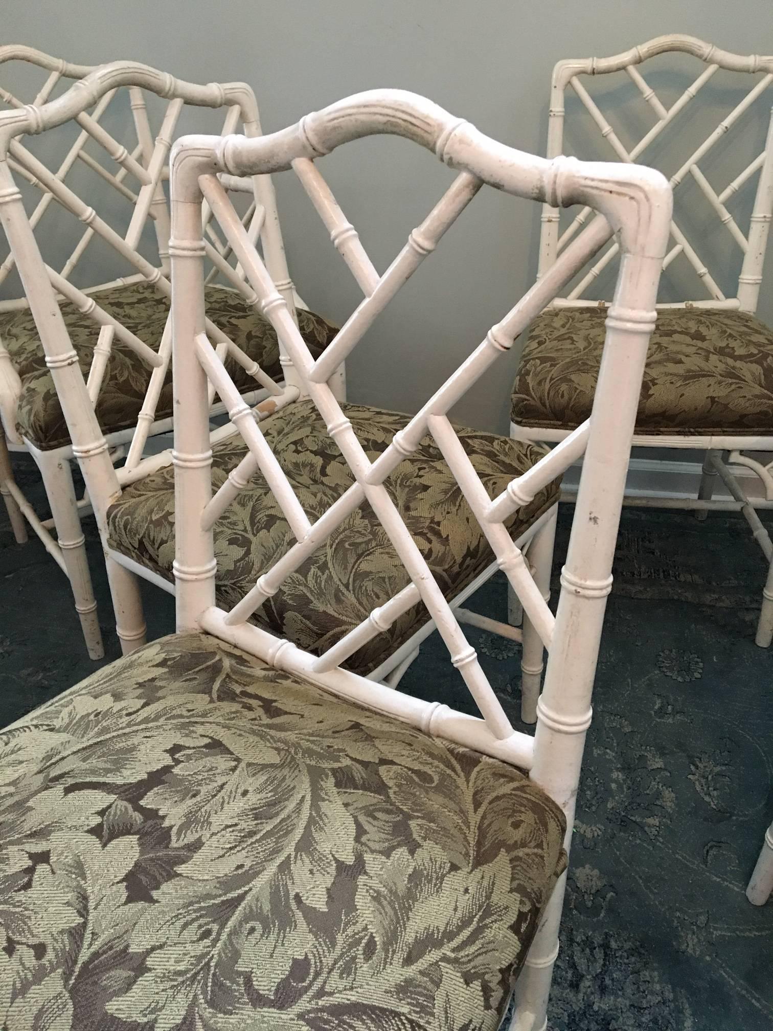 Set of six faux bamboo dining chairs in the iconic Asian Chippendale style. Four side chairs and two-arm chairs. Upholstered seats in excellent condition. Chairs are in good vintage condition with abrasions to finish.
As always, all reasonable