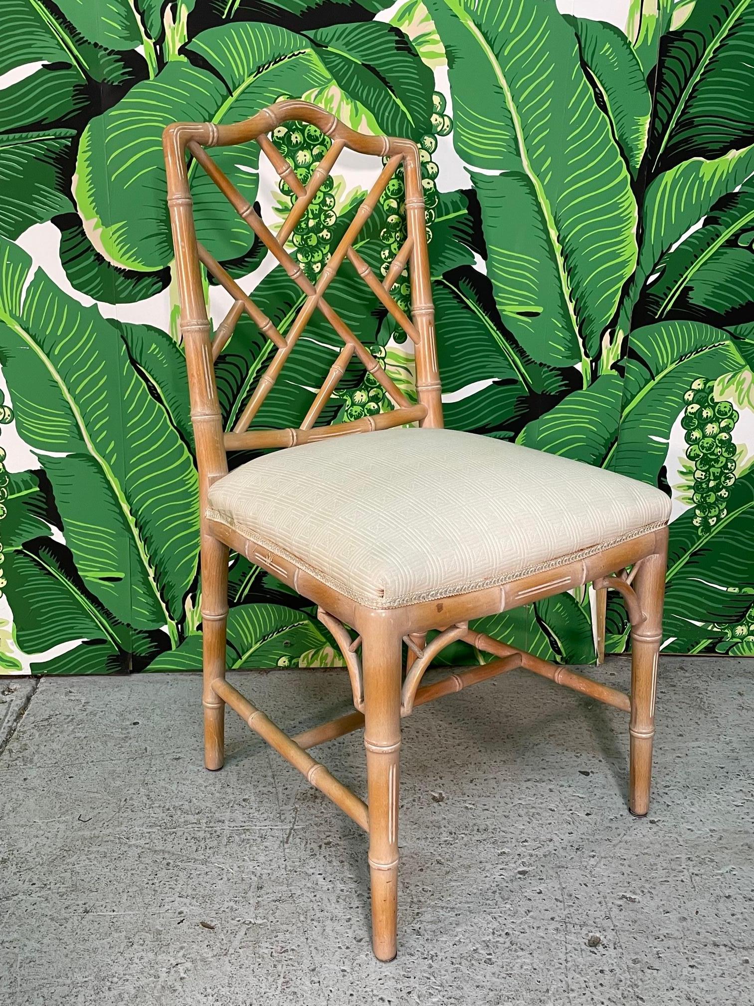 Set of six faux bamboo dining chairs in chinoiserie style. Glossy finish with neutral upholstery. Very good condition with only minor imperfections consistent with age. Heavy and structurally sound. A few light stains on upholstery. See photos for