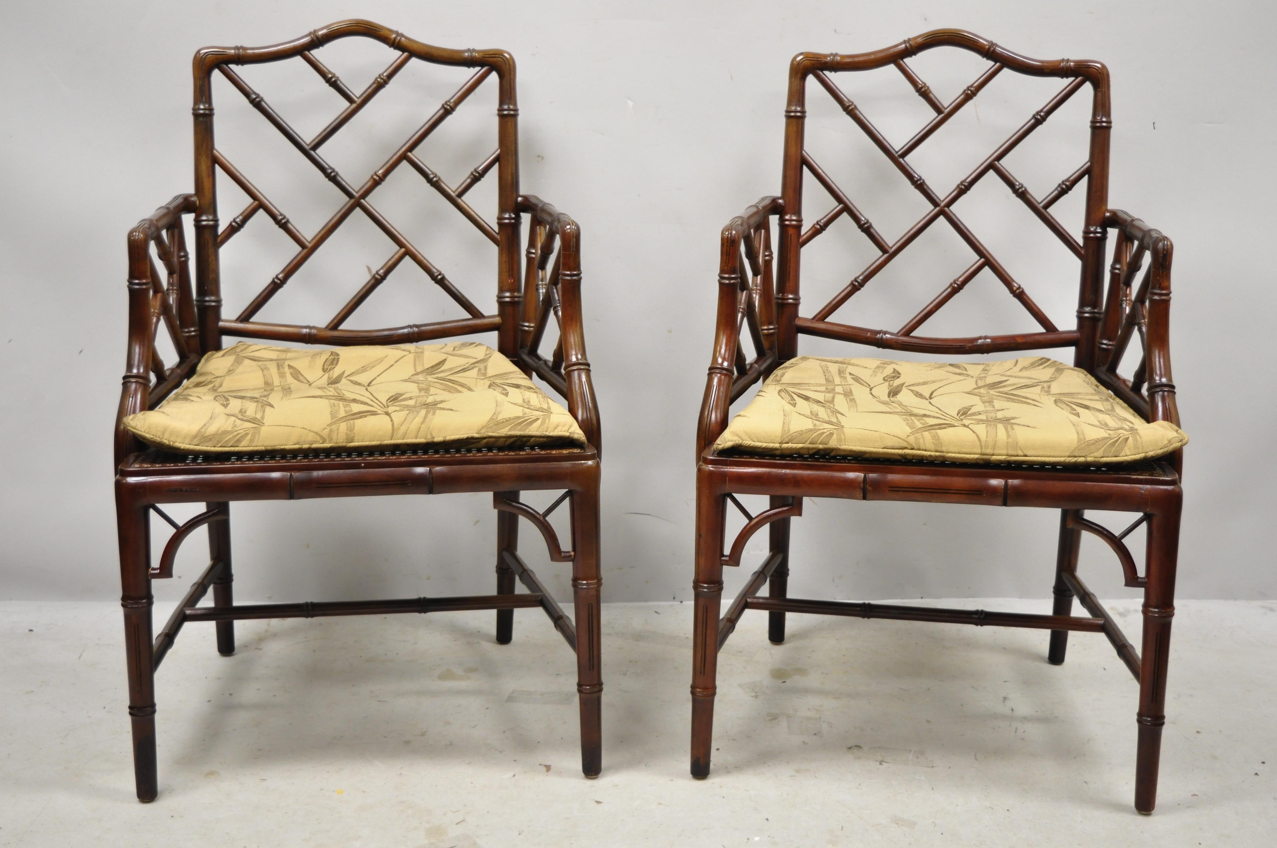 Vintage Chinese Chippendale faux bamboo Hollywood Regency cane armchairs (A) - a pair. Item features solid wood frame, distressed finish, nicely carved details, cane seat, quality American craftsmanship, great style and form, circa mid-late 20th
