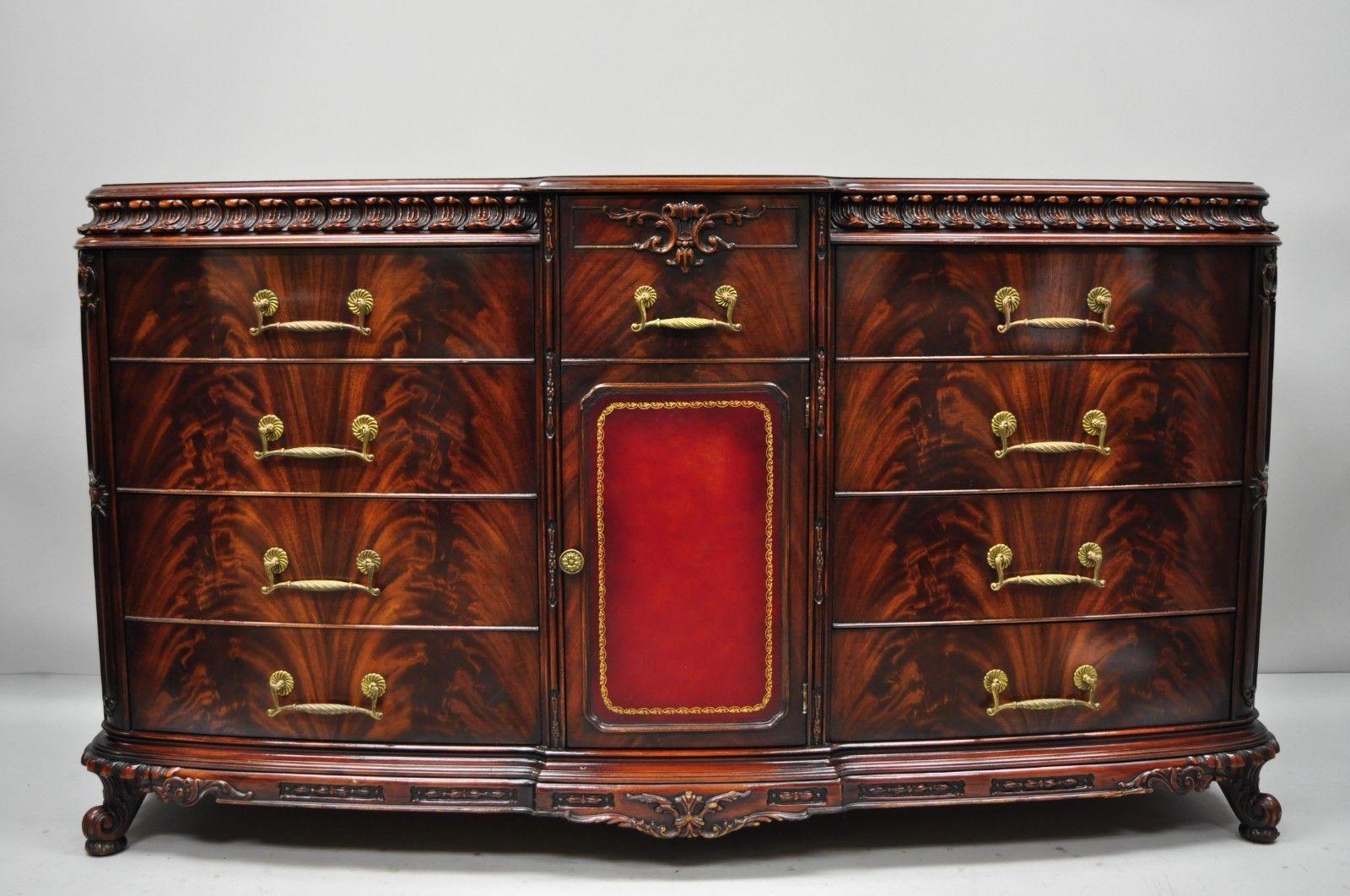 Chinese Chippendale flame mahogany triple dresser chest and mirror Detroit Furniture. Item ism made by Detroit Furniture Company of Brooklyn, NY, and features a center with red leather panel, beautiful flamed wood grain, ornately carved details, 12