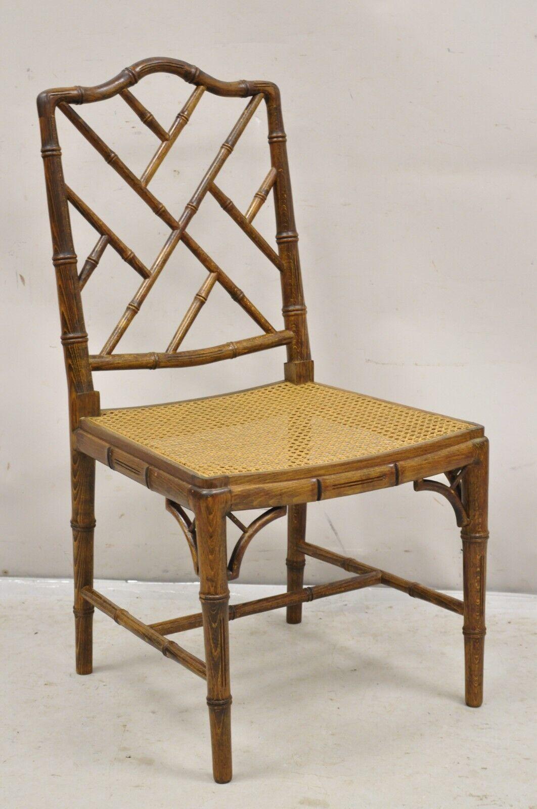 Vintage Chinese Chippendale Hollywood Regency Faux Bamboo Cane Dining Chairs - Set of 6. Item features 4 side chairs, 2 arm chairs, solid wood frames, cane seats, iconic faux bamboo design. Circa Mid 20th Century.
Measurements: 
Arm chairs: 36
