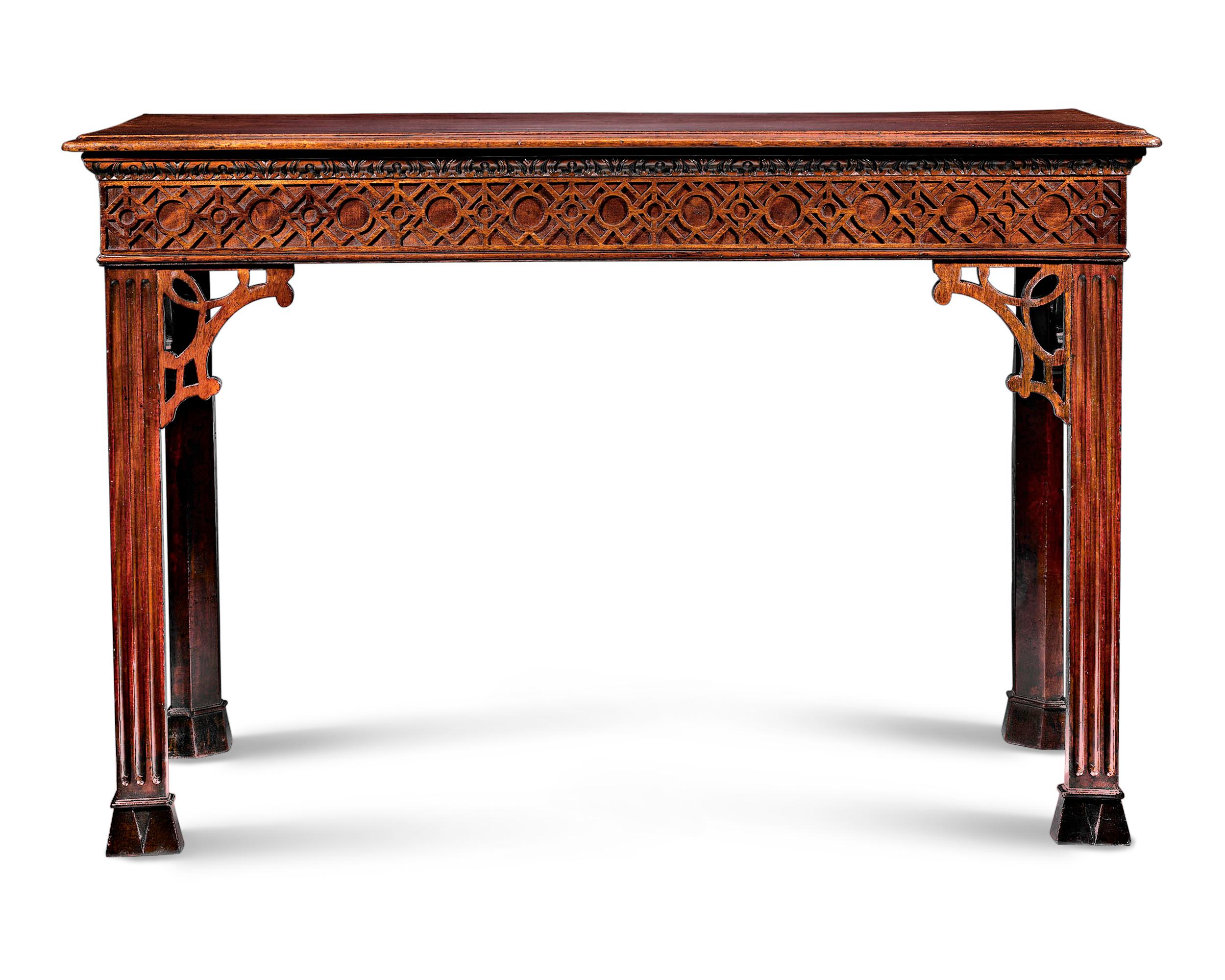 This English mahogany console table is a rare period example of the elaborate Chinese Chippendale style. A study in symmetry and balance, this table combines the restrained elegance of the Georgian period with the intricate artistry of the