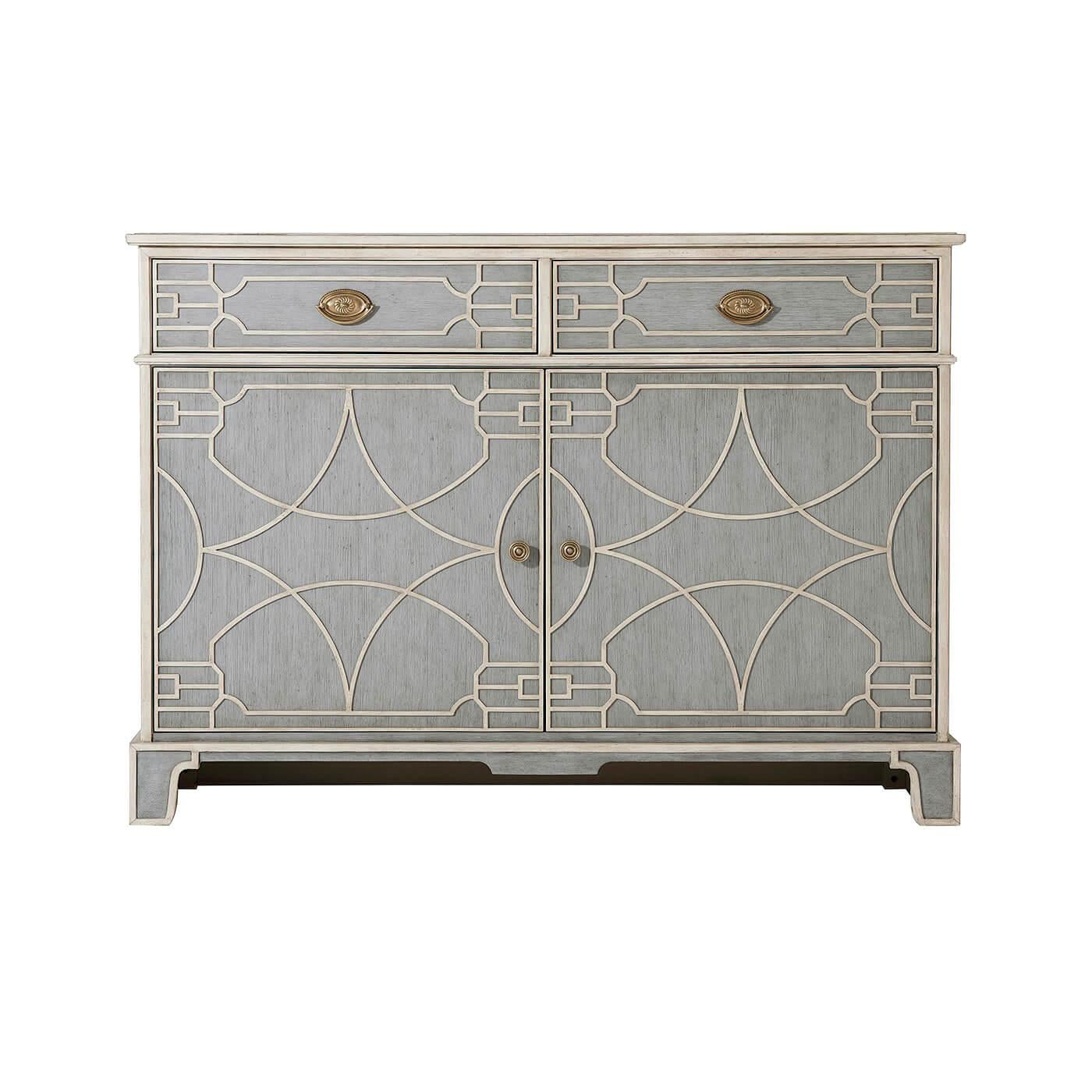 A hand-painted Chinese Chippendale style side cabinet with two blind fret carved frieze drawers with brass pull handles above two cabinet doors enclosing an adjustable shelf and raised on bracket feet.

Dimensions: 48