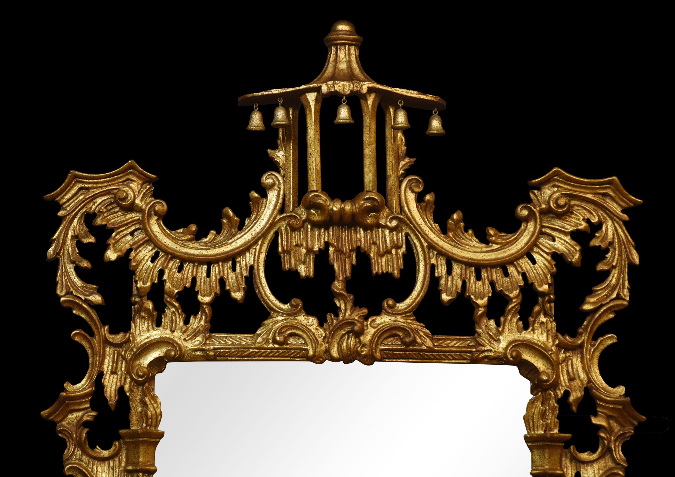 A Chinese Chippendale style carved giltwood wall mirror with pagoda surmount and hanging bells, above the original mirror plate, enclosed by carved frame of open rococo scrolls.
Dimensions
Height 63 Inches
Width 32 Inches
Depth 4.5 Inches