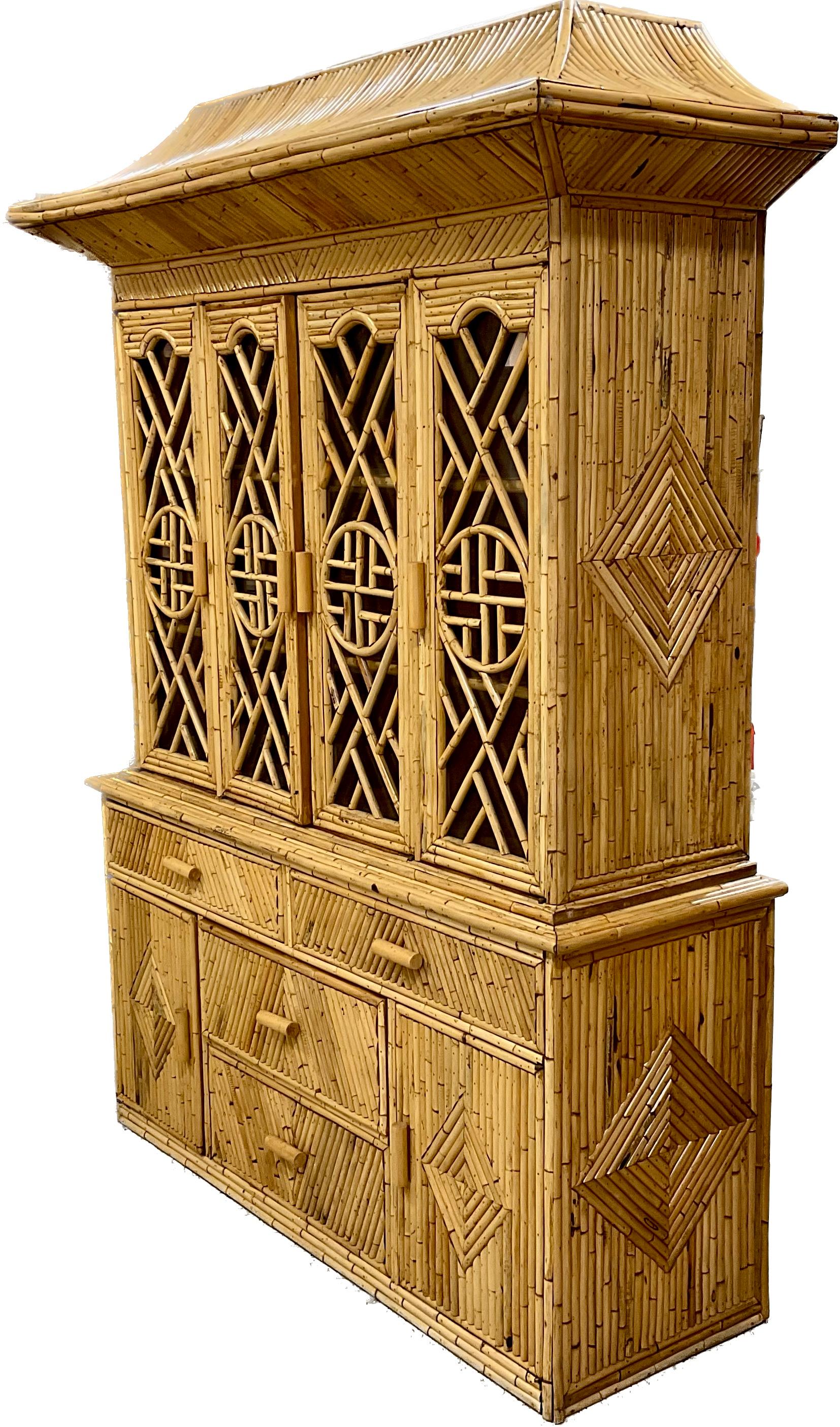 Stunning two part Pagoda Shape pencil reed rattan Cabinet in two parts with interior shelves in the top and drawers and cabinets in the bottom for plenty of storage and display.  Chinese Chippendale Brighton Pavillion style mid century Palm Beach