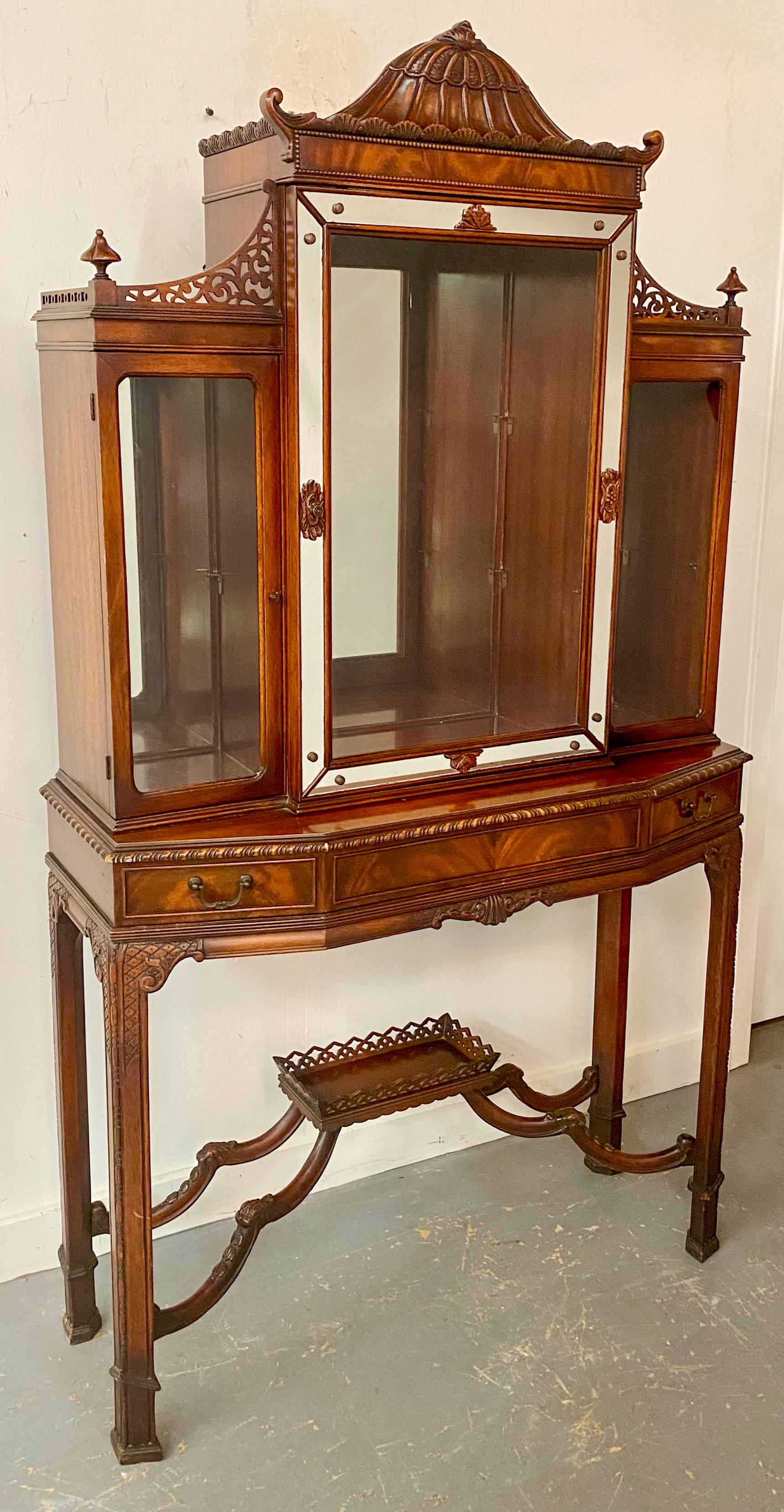 The two-piece Chinese Chippendale style Vitrine, cabinet or secretary desk  shows fine and quality carving design.  Made of mahogany wood, the Chinese chippendale style vitrine features three doors, the center one is the largest having mirrored