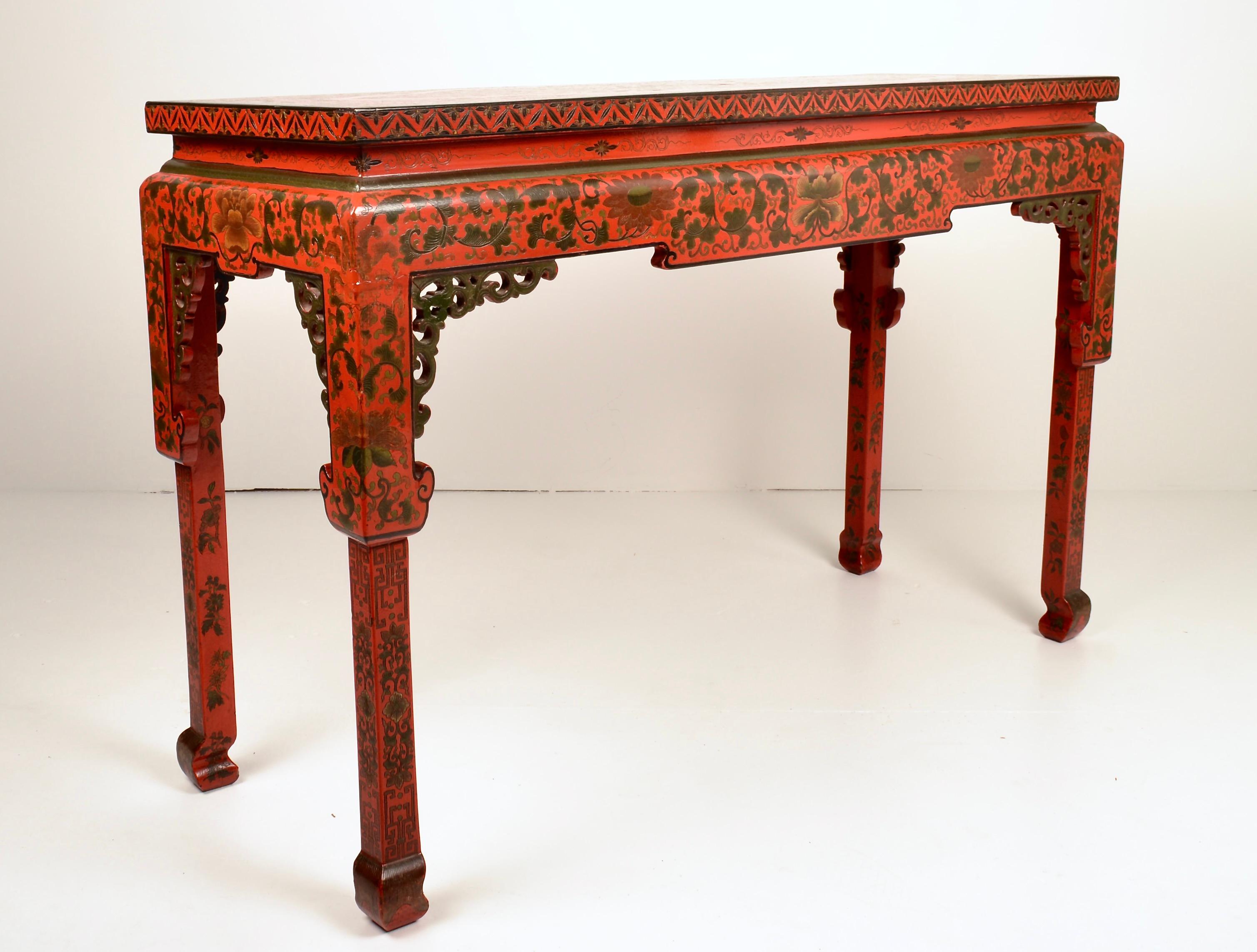 Wonderful attention to detail makes this console outstanding, from finely hand painted decoration, carved fretwork, incised greek key border to classic Chinese Chippendale form.  And that vibrant red color!  Very fine, almost perfect condition.
