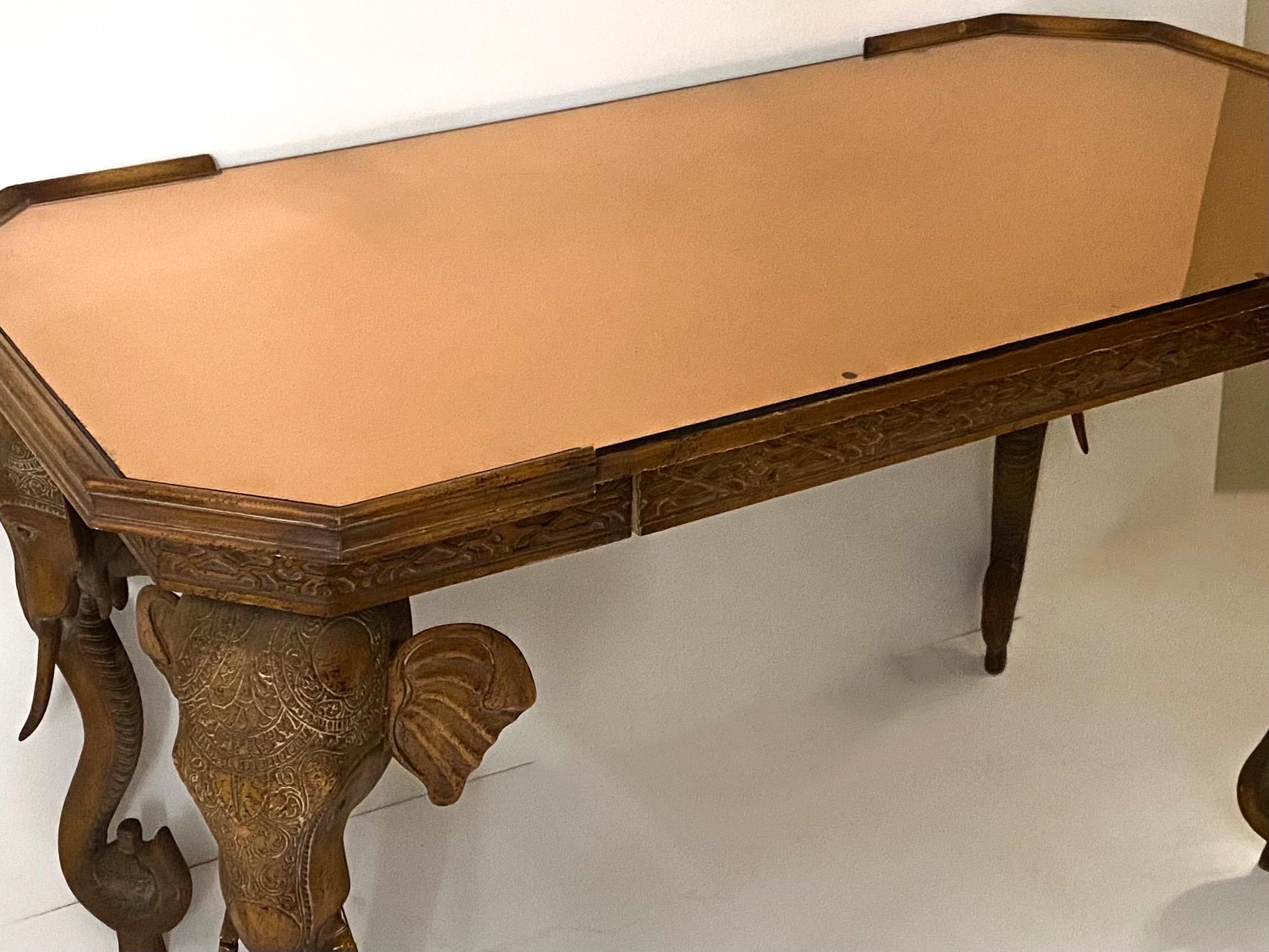 This is a 1970s Chinese Chippendale style elephant form desk attributed to Gampel-Stoll. It has a removable copper washed mirror top includes the original pagoda chair. The desk has a single drawer, and the fretwork wraps around the desk. The desk