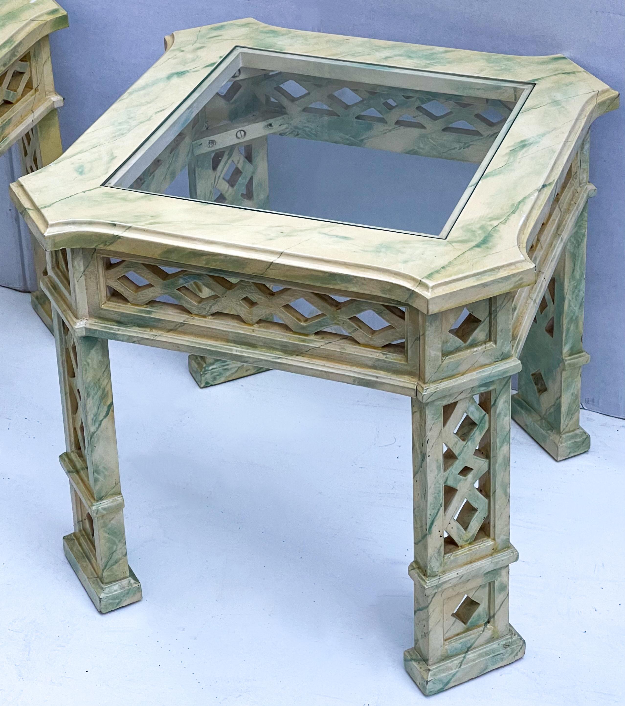 This is a pair of 1970s Chinese Chippendale style side tables that are painted with a faux marble finish, they are attributed to Tomlinson. The glass inserts are removable. The paint is cream with green veining.