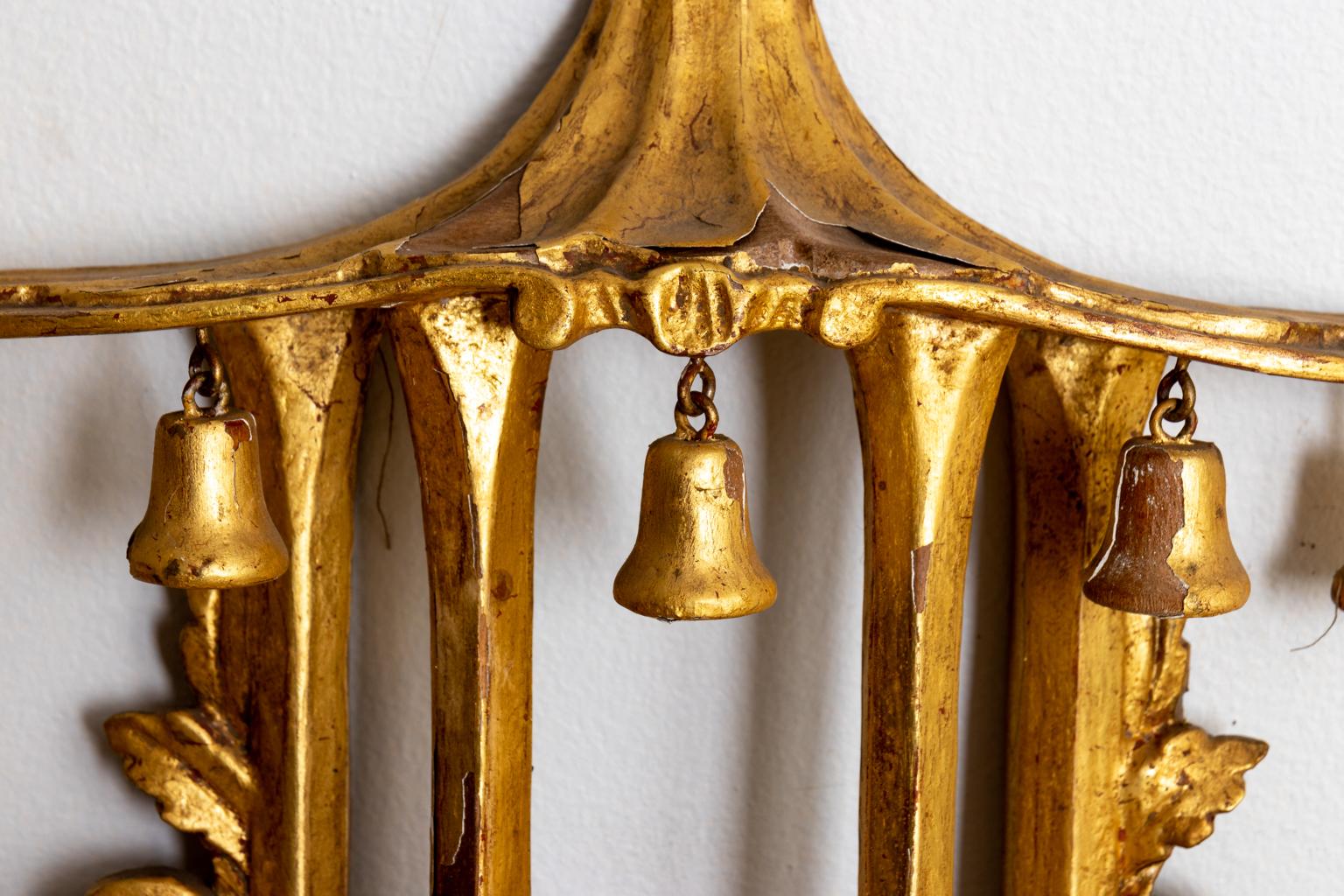 Chinese Chippendale style gilt and gesso mirror, ornately carved with a pagoda shaped crown and scrolled foliage throughout the frame. Please note of wear consistent with age including minor finish loss.