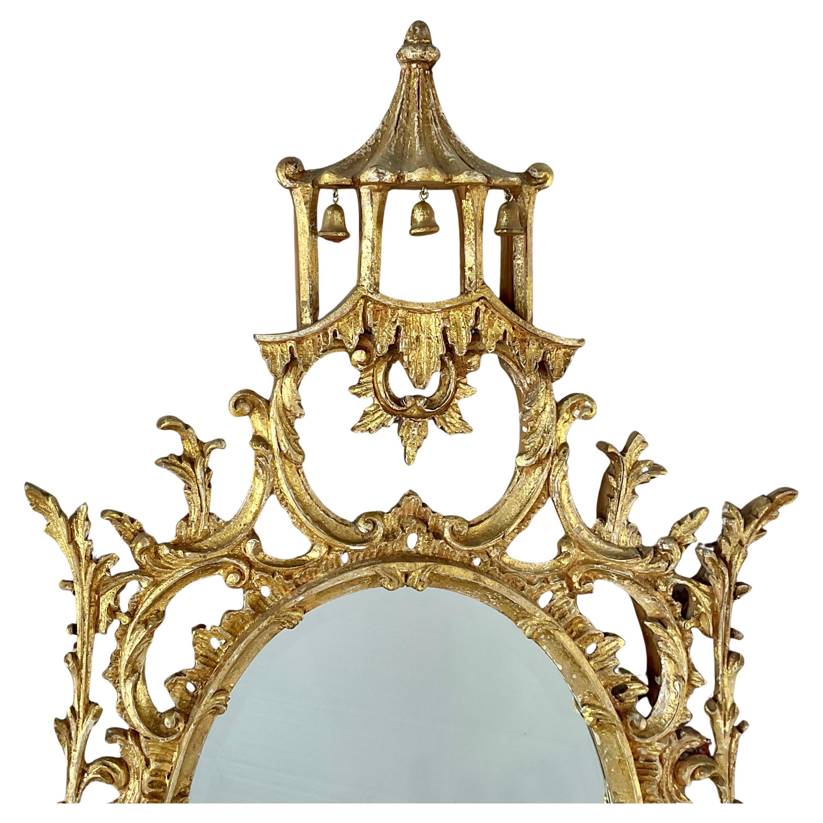 Lovely early 20th Century Italian Giltwood Wall Mirror. Oval shaped mirror is made in the Chinese Chippendale style featuring intricate carvings and ornamental details, with exotic birds and a pagoda at the top. 