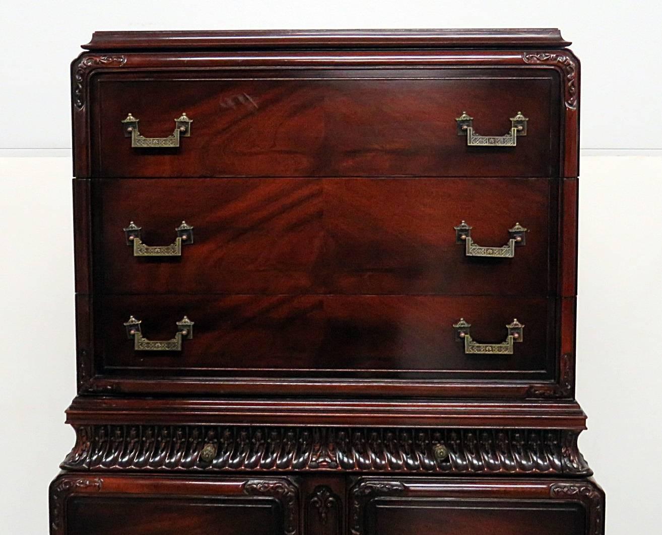 Chinese Chippendale style highboy with three drawers over two doors with two drawers.