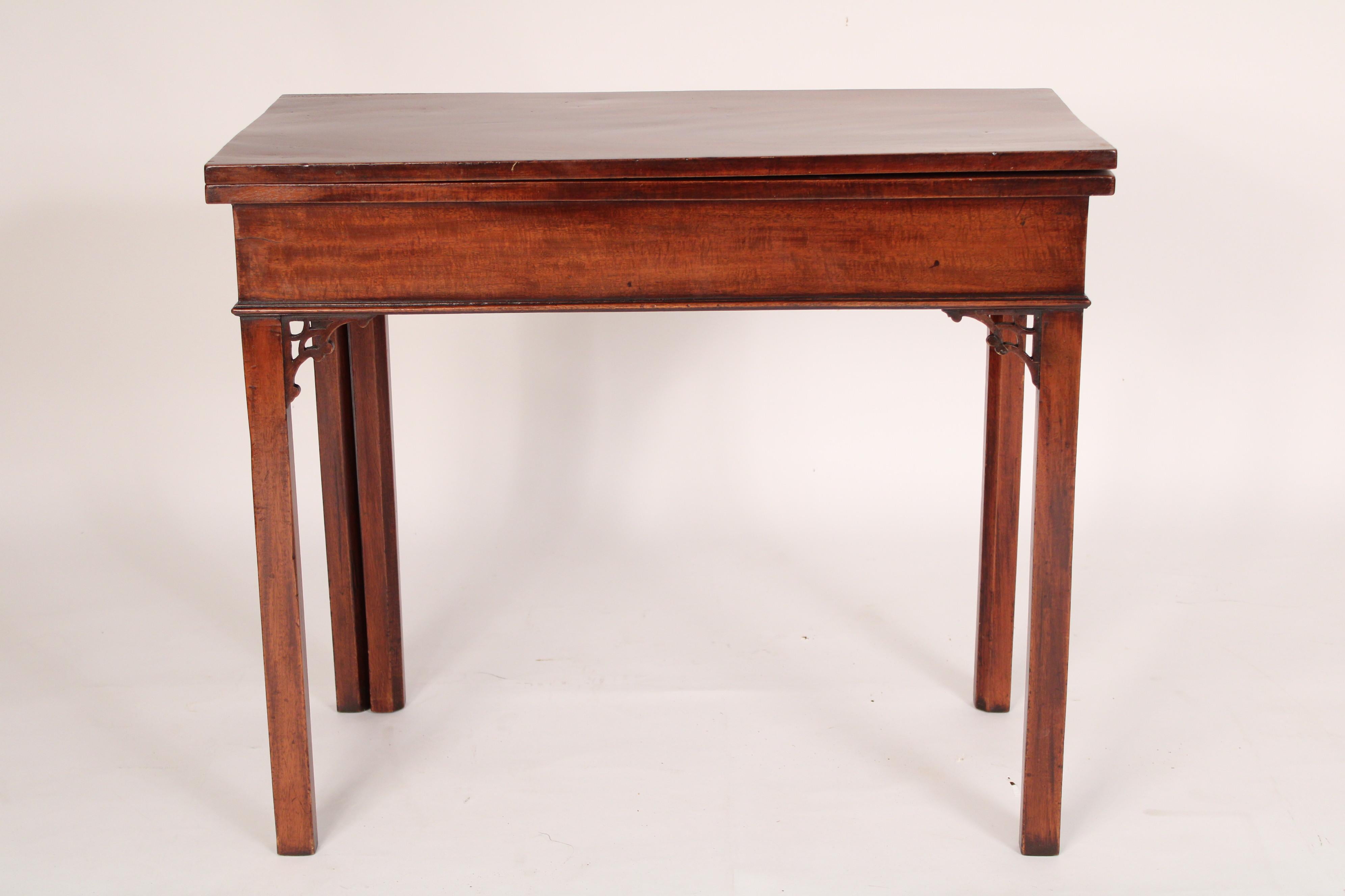 Chinese Chippendale style mahogany games table, 19th century. With an overhanging fold over crotch mahogany rectangular top, a plumb pudding mahogany frieze, Chinese Chippendale style corner brackets, resting on 5, 5 sided legs. When opened the top