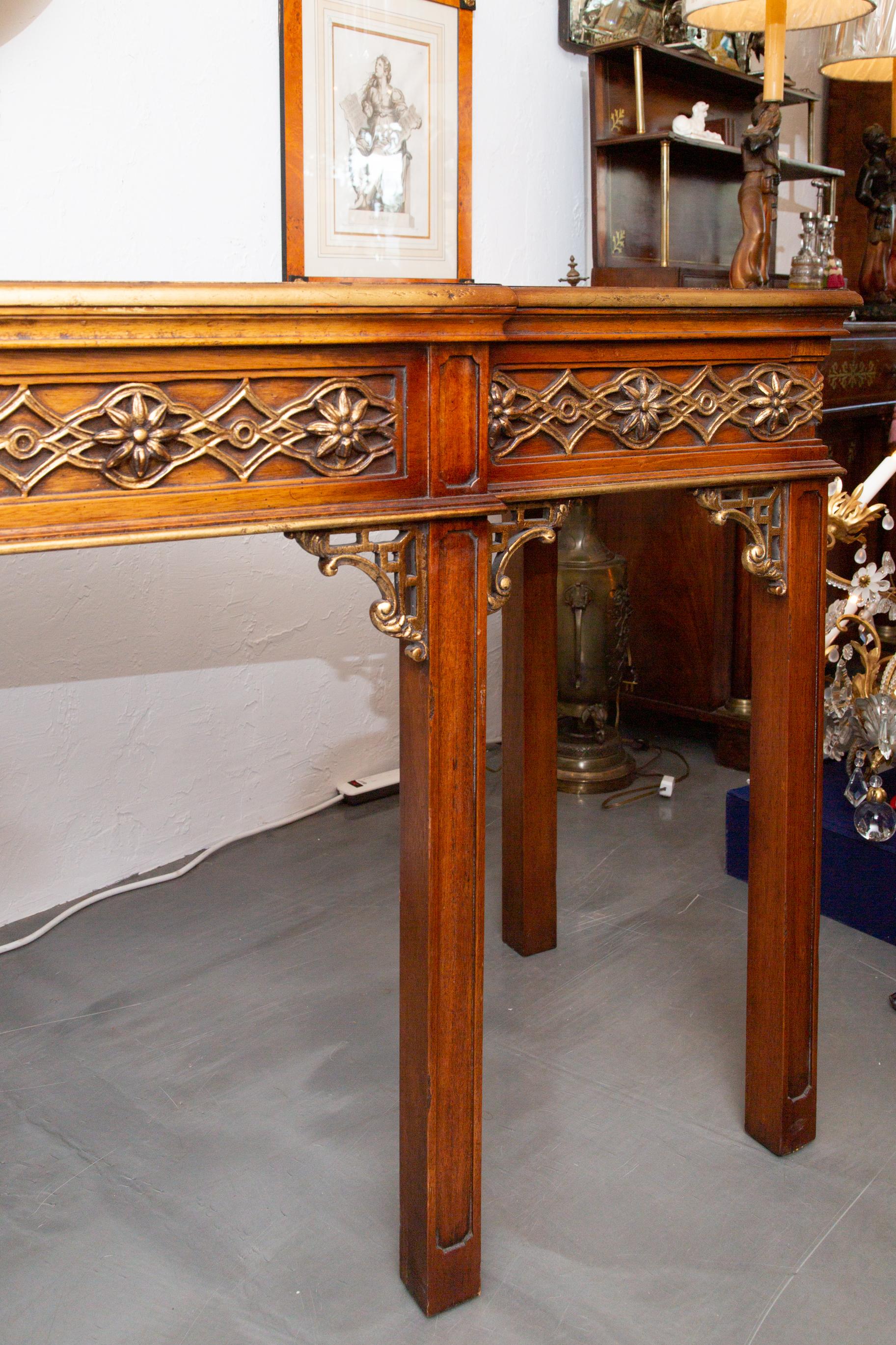 This is a very stately Chinese Chippendale style walnut and parcel gilt console or sofa table. It’s very traditional, but the parcel gilt and Chinese Chippendale fret work give the piece punch.