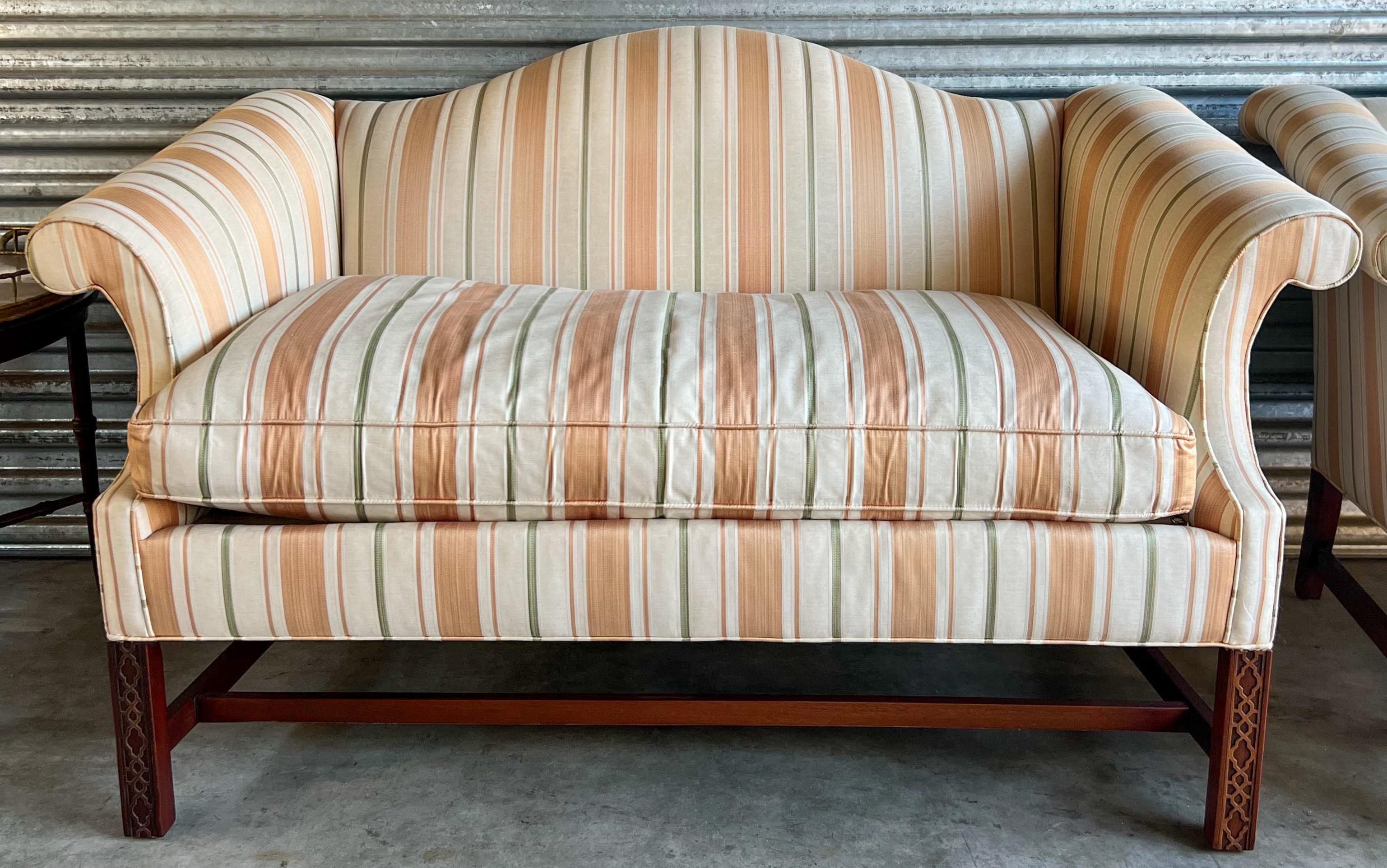This is a pair of 20th century Chinese Chippendale style settees by the American manufacturer, Southwood & Co. They are marked, and the vintage striped upholstery is in very good condition.