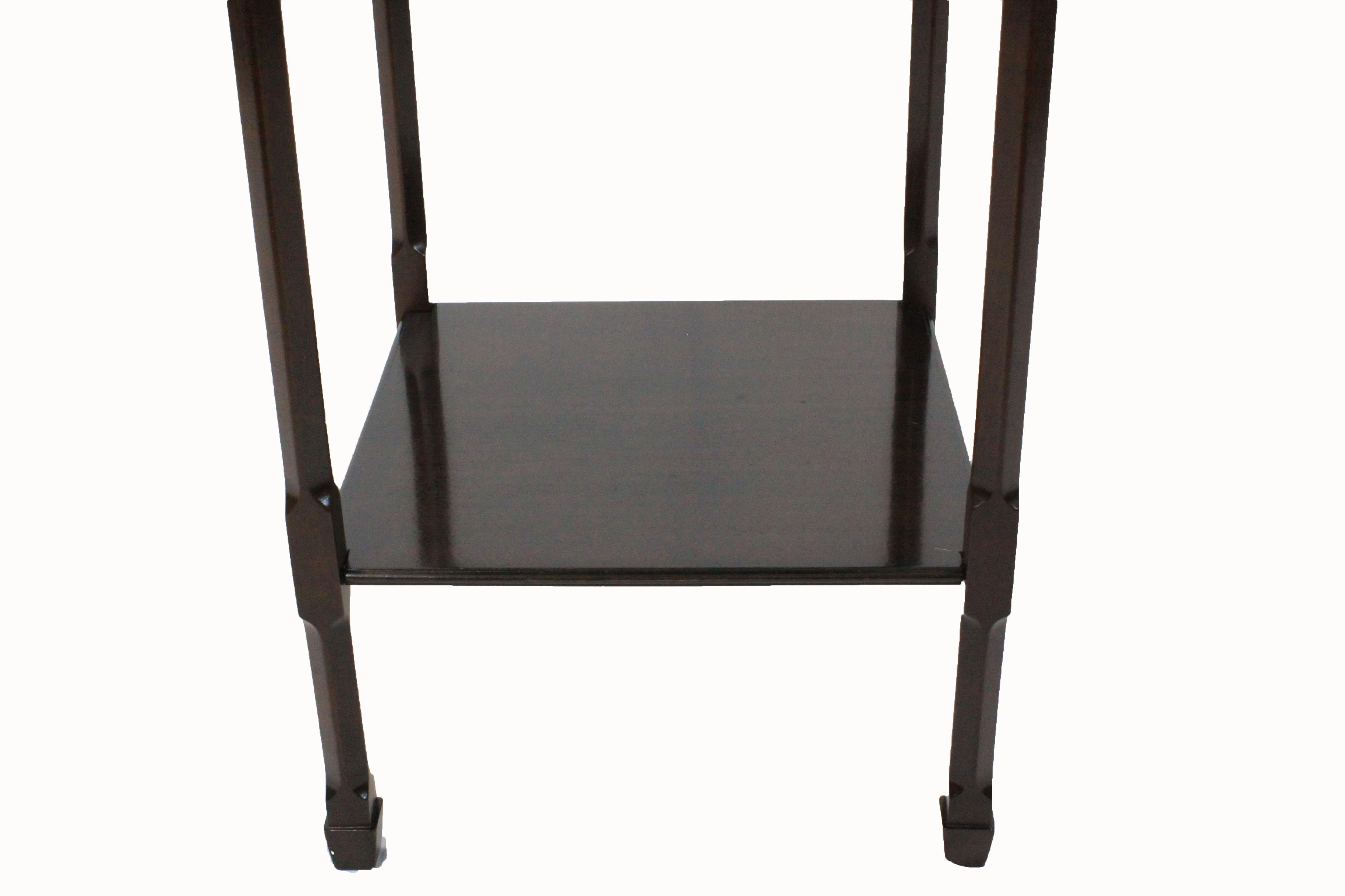 Two-tier mahogany side table in Chinese Chippendale style with fretted frieze and pierced fretted corner brackets.