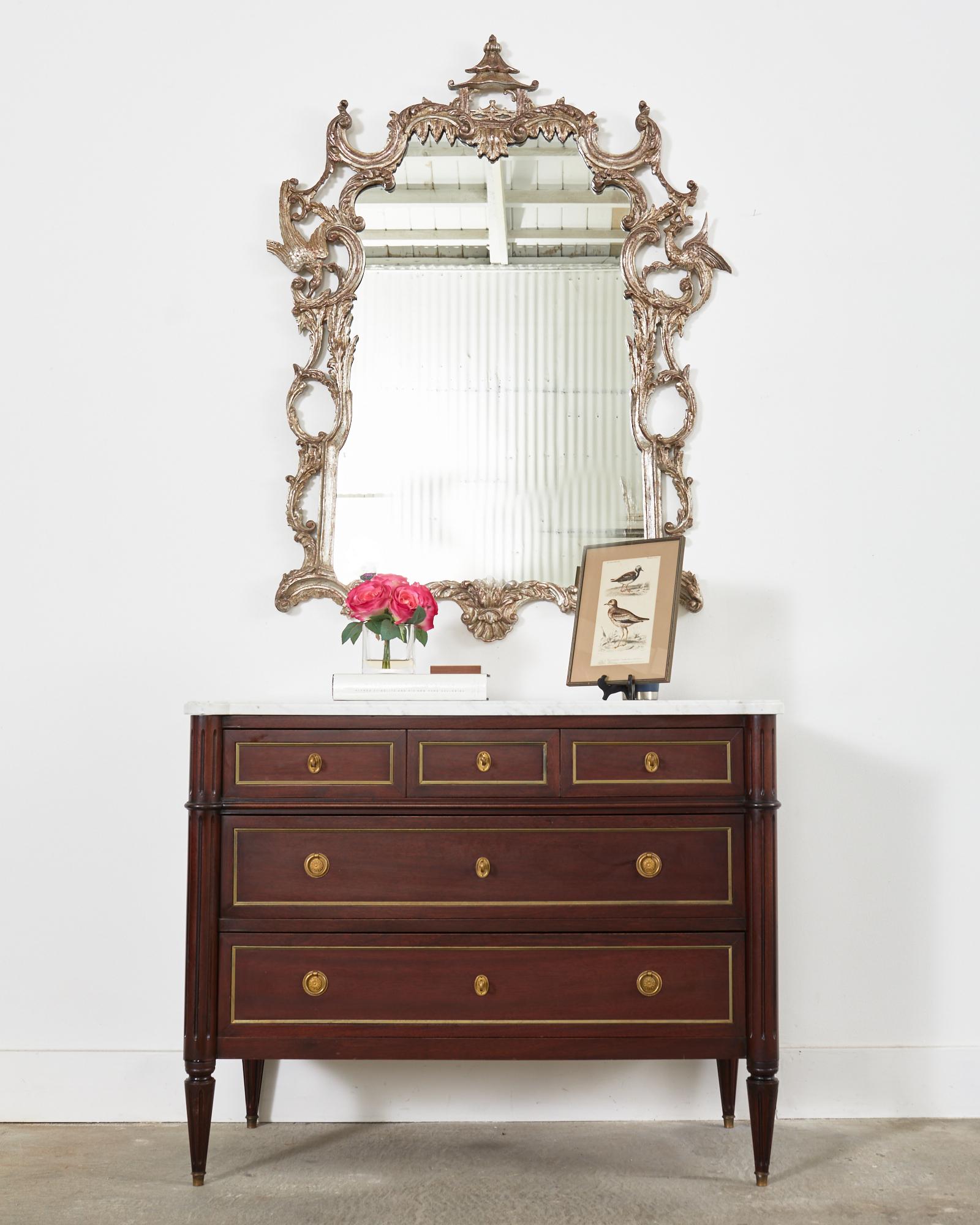 Opulent Italian silver gilt pagoda mirror made in the George III Chinese Chippendale taste. The large wood framed mirror features an applied silver gilt finish with an intentionally aged patina. The frame is crafted from C scrolls decorating the