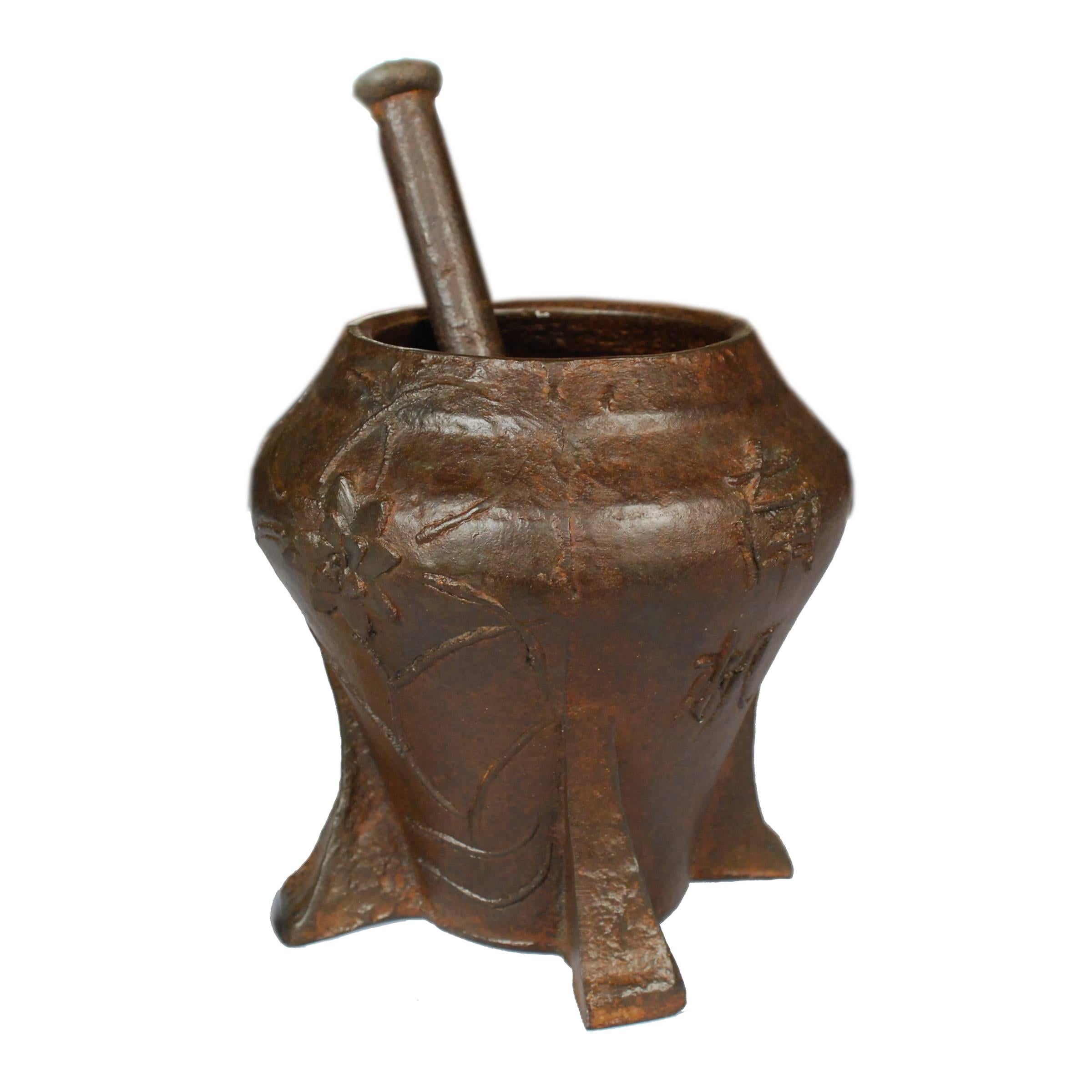 This vintage mortar and pestle from Shanxi, China was cast in iron with a floral relief. It was originally used in a traditional apothecary to create herbal medicine. The container happens to be just the right size to beautifully accommodate a