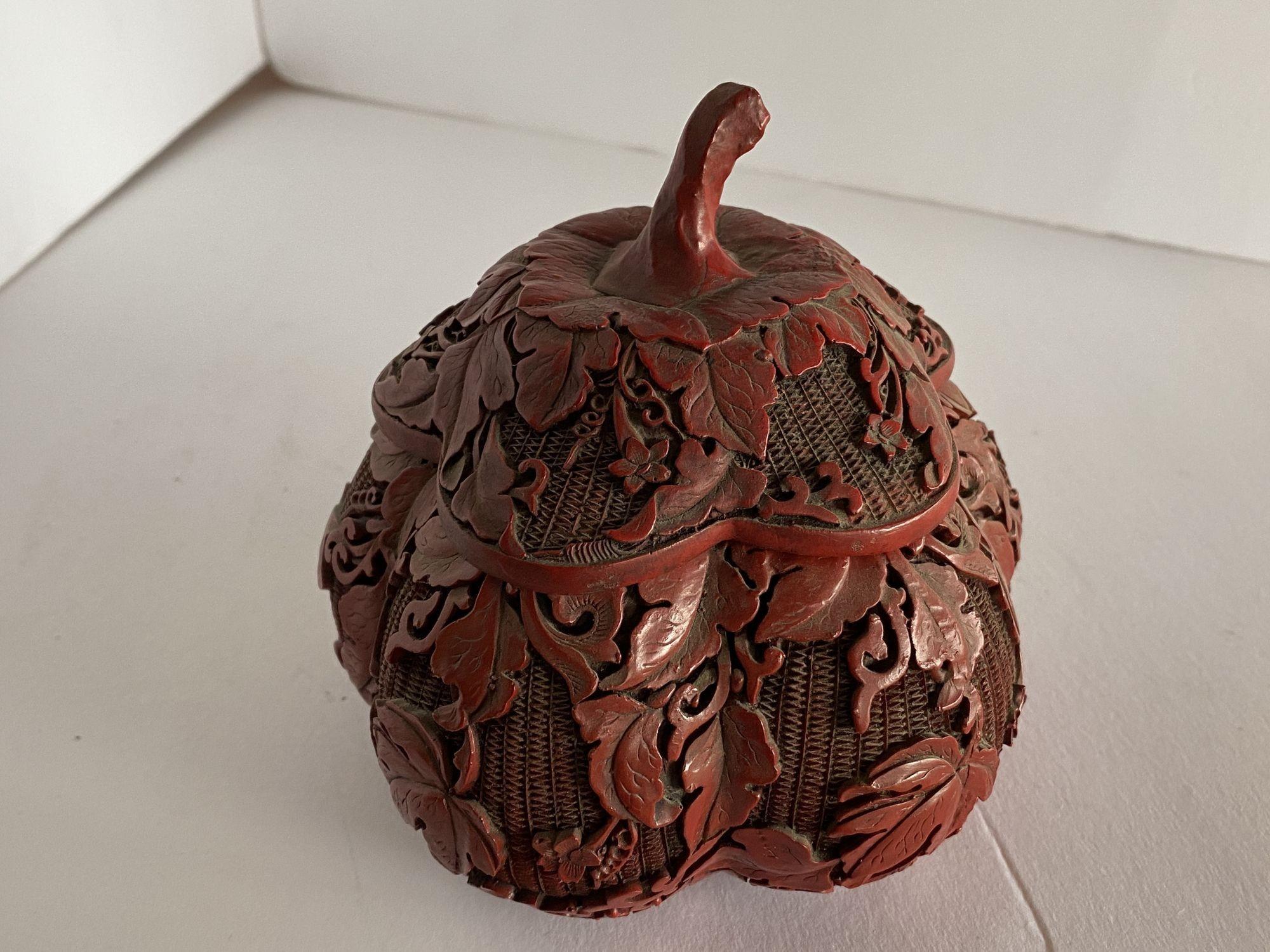 A small hand-carved pumpkin shape Cinnabar lidded container with heavy carving to the top and sides with a leaf motif. Black coloring to the inside and to the bottom of the piece, is a very well crafted and beautifully executed piece of art.
 
 