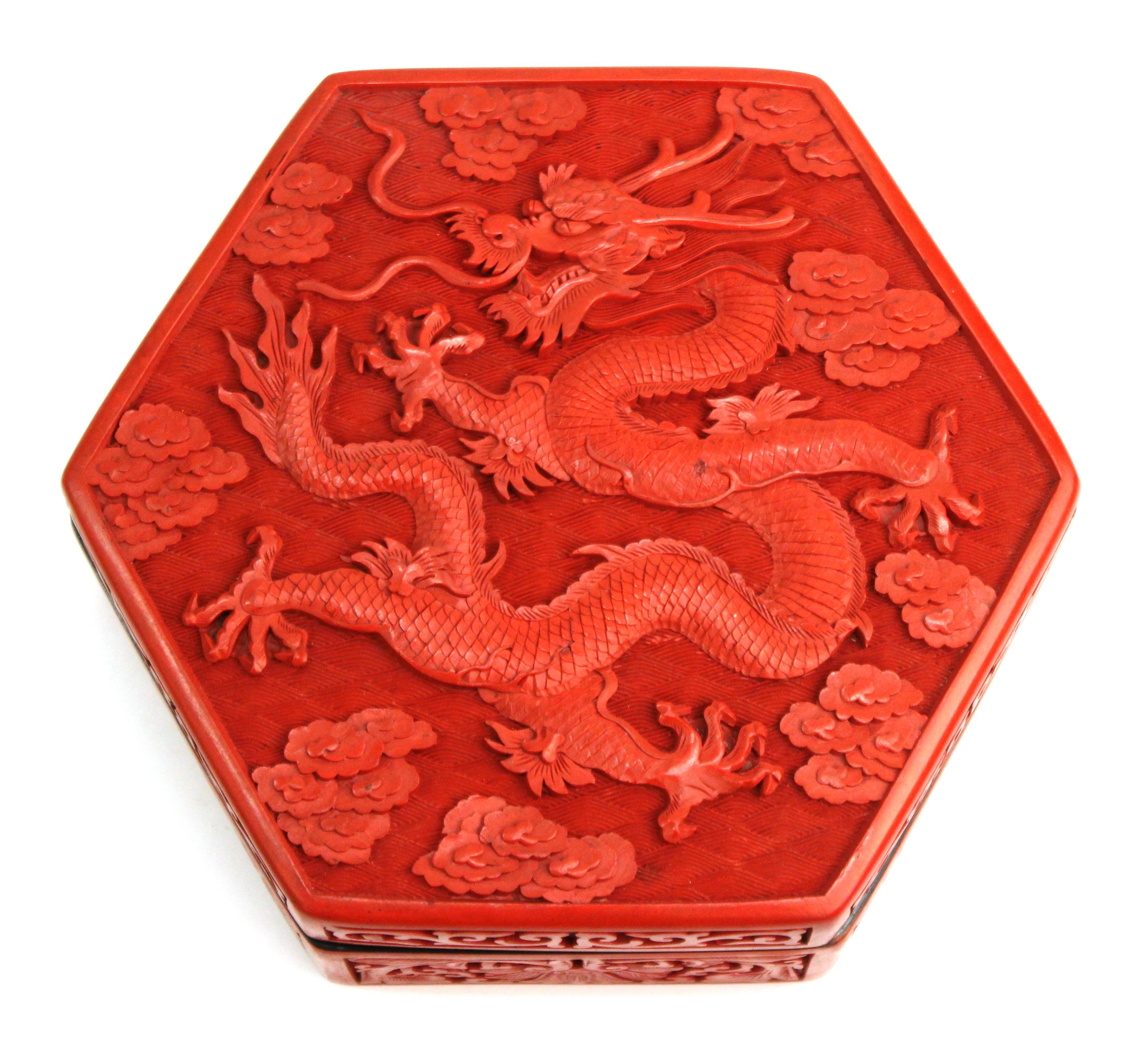 Chinese hexagonal red lacquer cinnabar box with elaborate carved dragon motif on the lid. The piece dates from the 1930s and is in great vintage condition with age-appropriate wear.