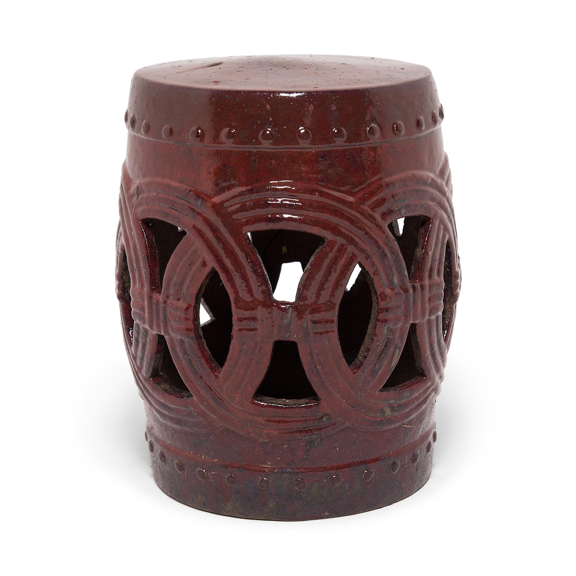 Hand-formed by an artisan in southern China, this early 20th century garden stool has a traditional drum-form design. Ringing both its top and bottom, a pattern of boss-head nails imitates those used to stretch a skin on an actual drum. Interlocking