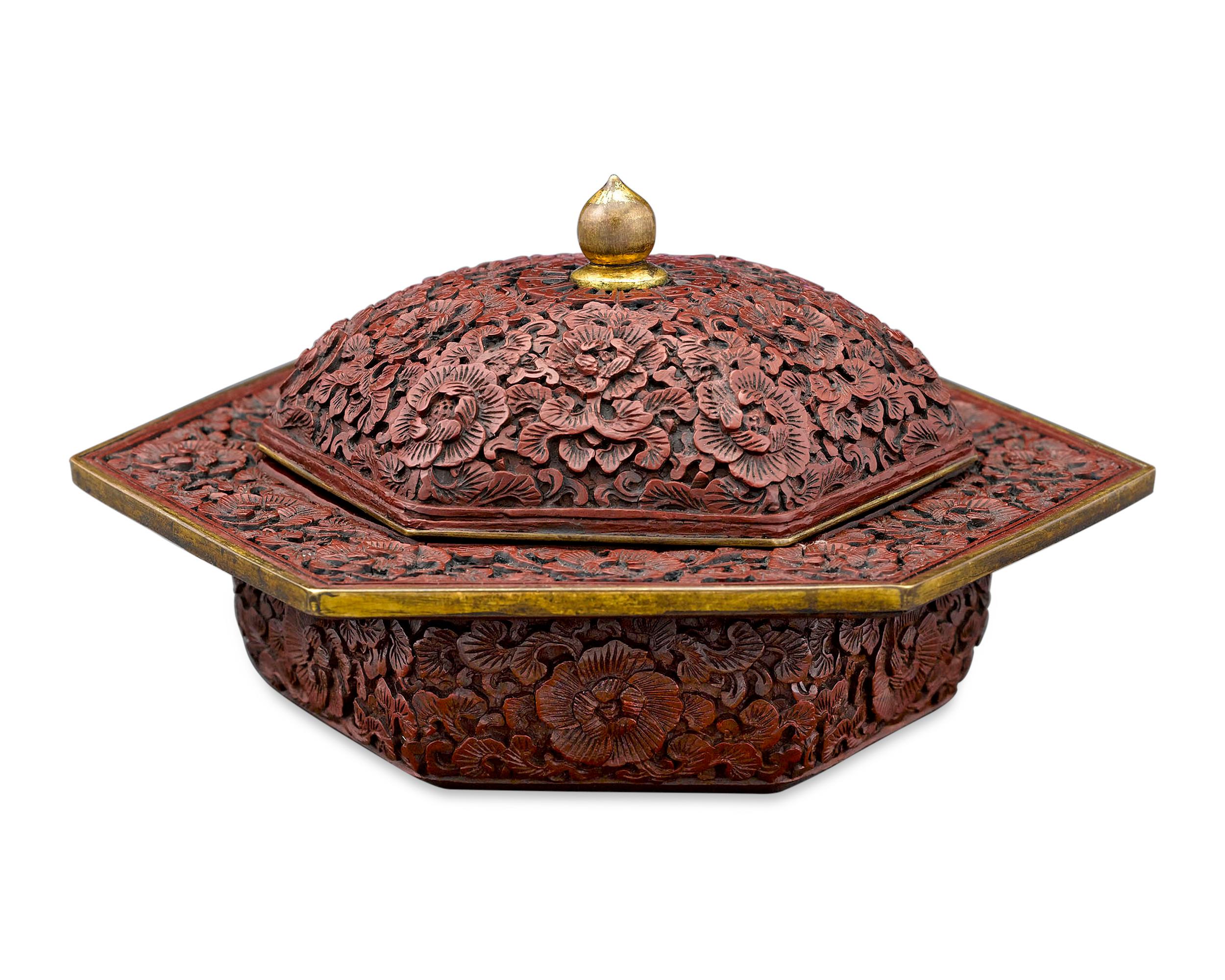 This intriguing Chinese zhadou is intricately carved of fine cinnabar lacquer. A work of exceptional artistry, this covered bowl is adorned with an intricately carved floral motif on all surfaces, including the cover and the wide rim. Also known as