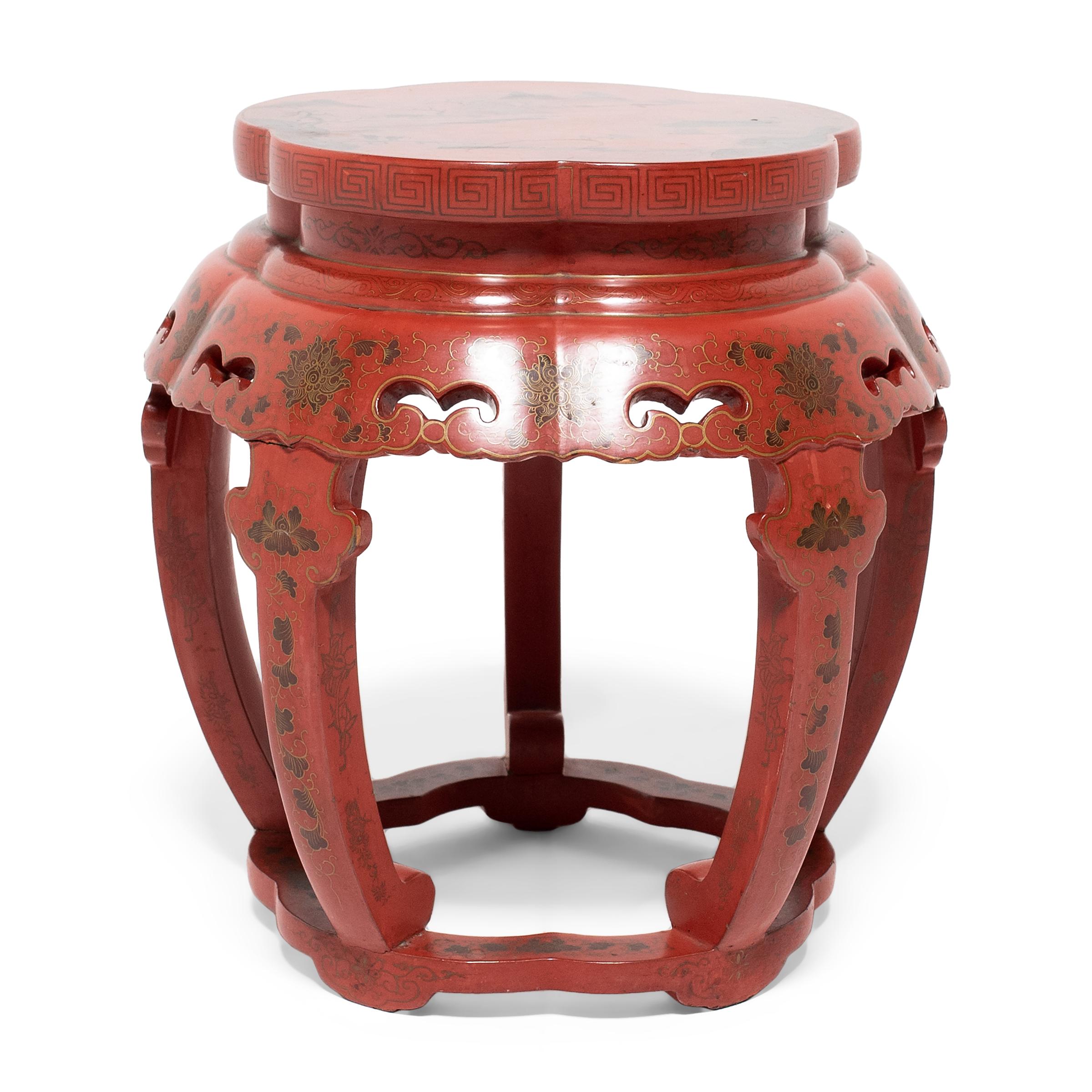Dated to the early 20th century, this painted red lacquer stool is a charming variation of the traditional drum form. Crafted in the style of Qing-dynasty furniture, the stool features a waisted top, a scalloped apron with simple cutouts, and five