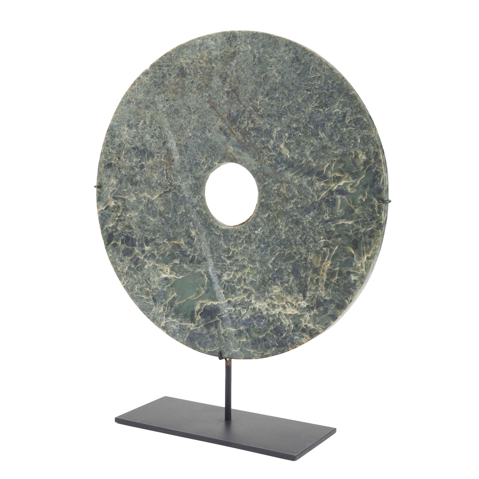 Circular carved jade bi disc mounted on a custom stand. The marble is rich with blue, green, tan, and brown tones and has deep visual depth. In China, the Bi is a symbol of moral character and social rank, used ceremonially to designate a person's