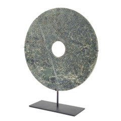 Chinese circular cut jade bi on stand