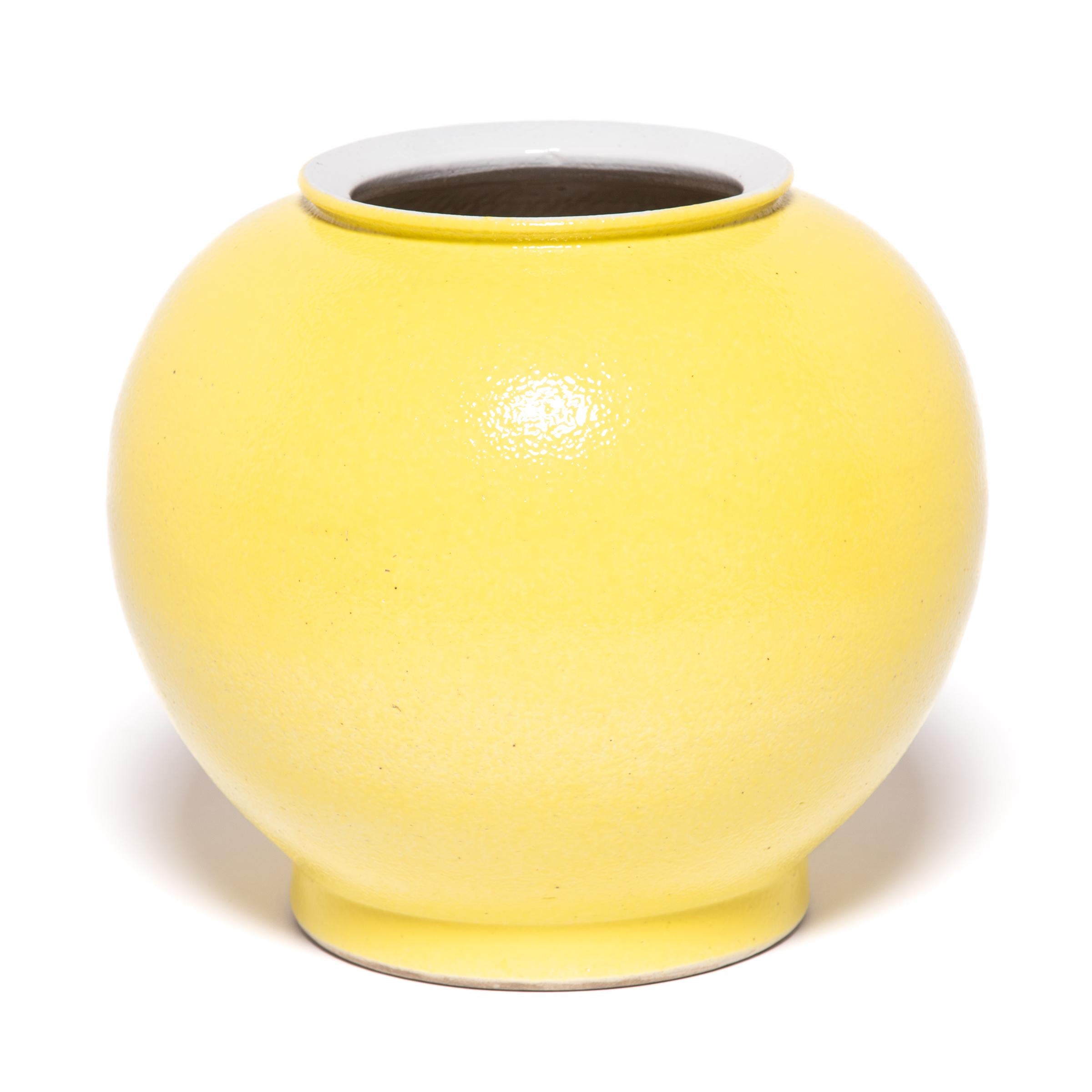 The striking bright yellow of this vase draws on a long Chinese tradition of glazing sculptural forms with a single, statement-making color. This contemporary take cloaks the round curves of the onion vase form in a glossy, citron yellow. Considered