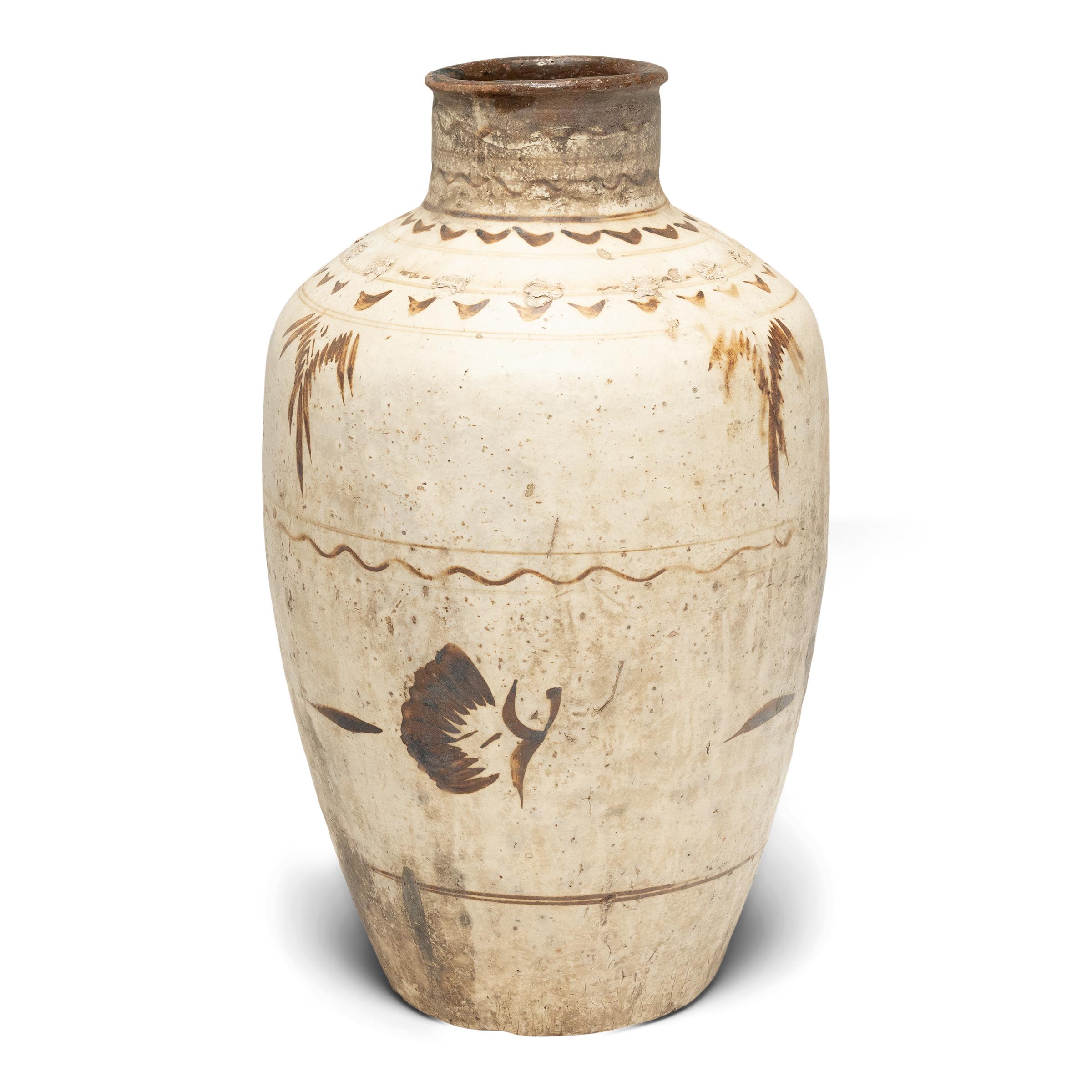 This glazed vessel dates to the mid-19th century and was used to store wine and spirits made from rice and other grains. The jar has an elegant, tapered form and is beautifully glazed with neutral earth-tones in a style characteristic of cizhou