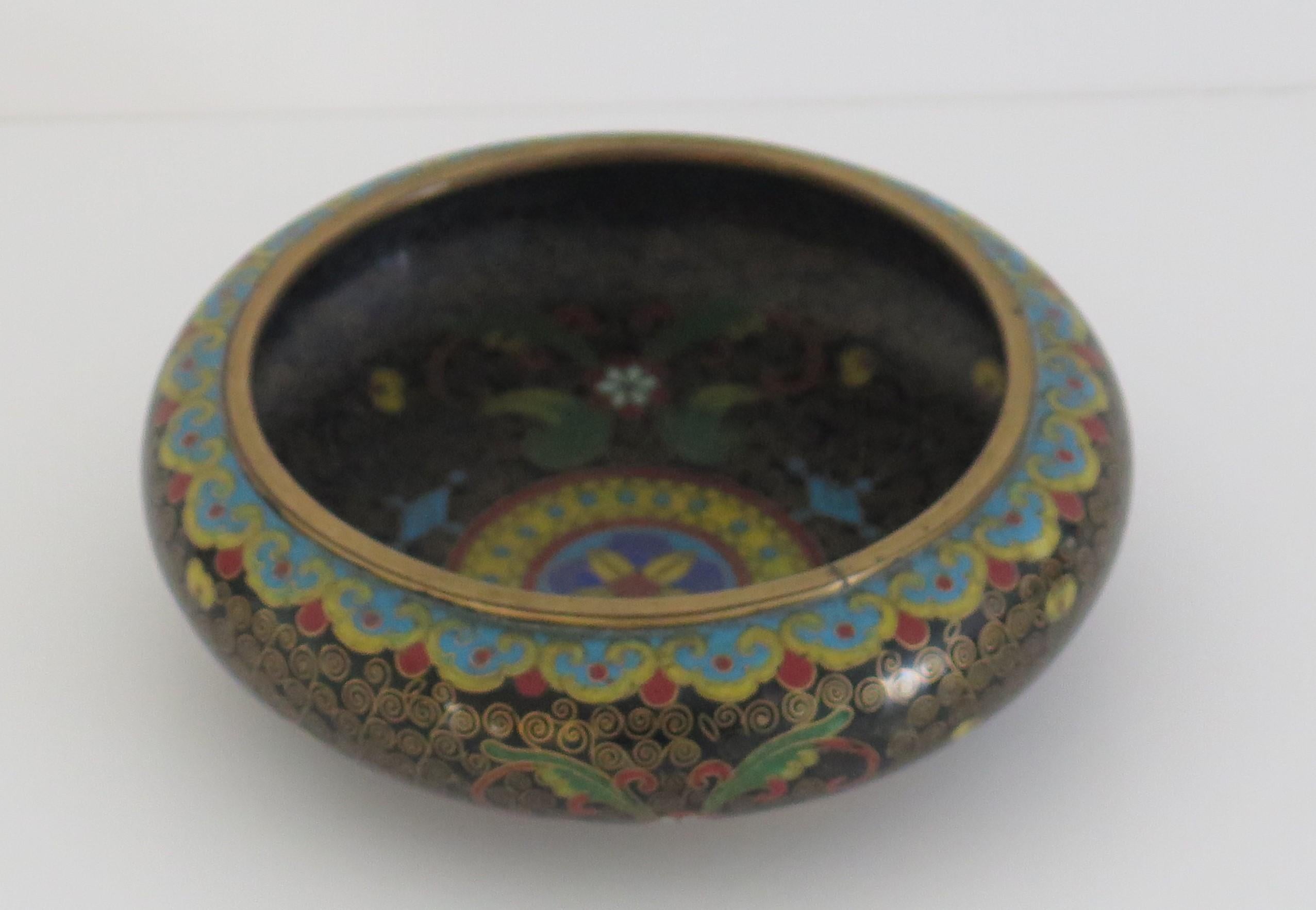 This is a good shallow cloisonne bowl made in China in the mid-19th century.

The bowl is circular with a short foot, beautifully made of bronze with rich, bold colorful enamels, intricate in its making and design.

The decoration shows stylized