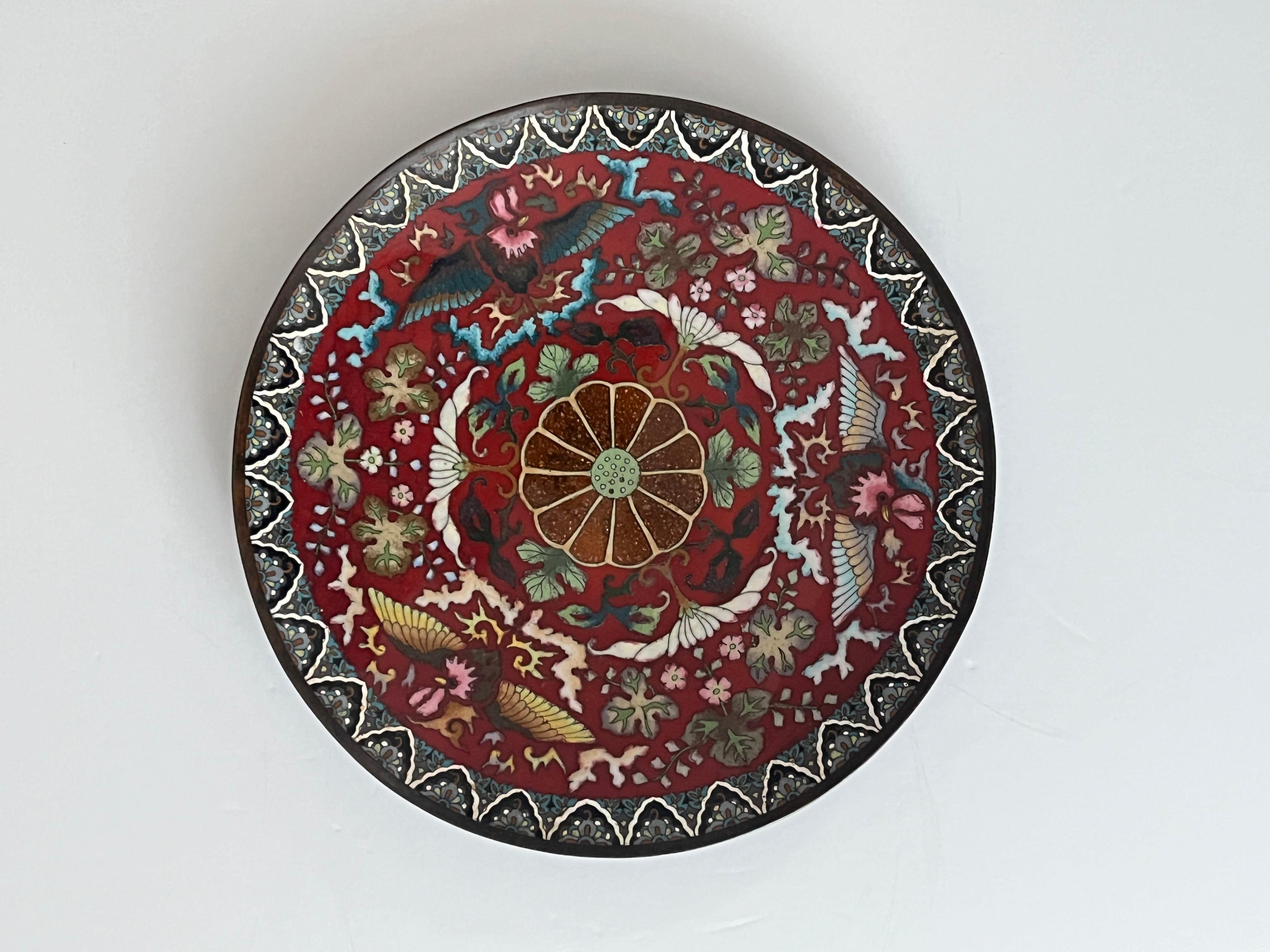This is a very good Chinese Cloisonné Charger or Large Plate / Dish that we date to the mid-19th century of the Qing dynasty, Circa 1970.

The Charger is circular on a low foot.

The decoration shows a large central 12-lobed flower head with further