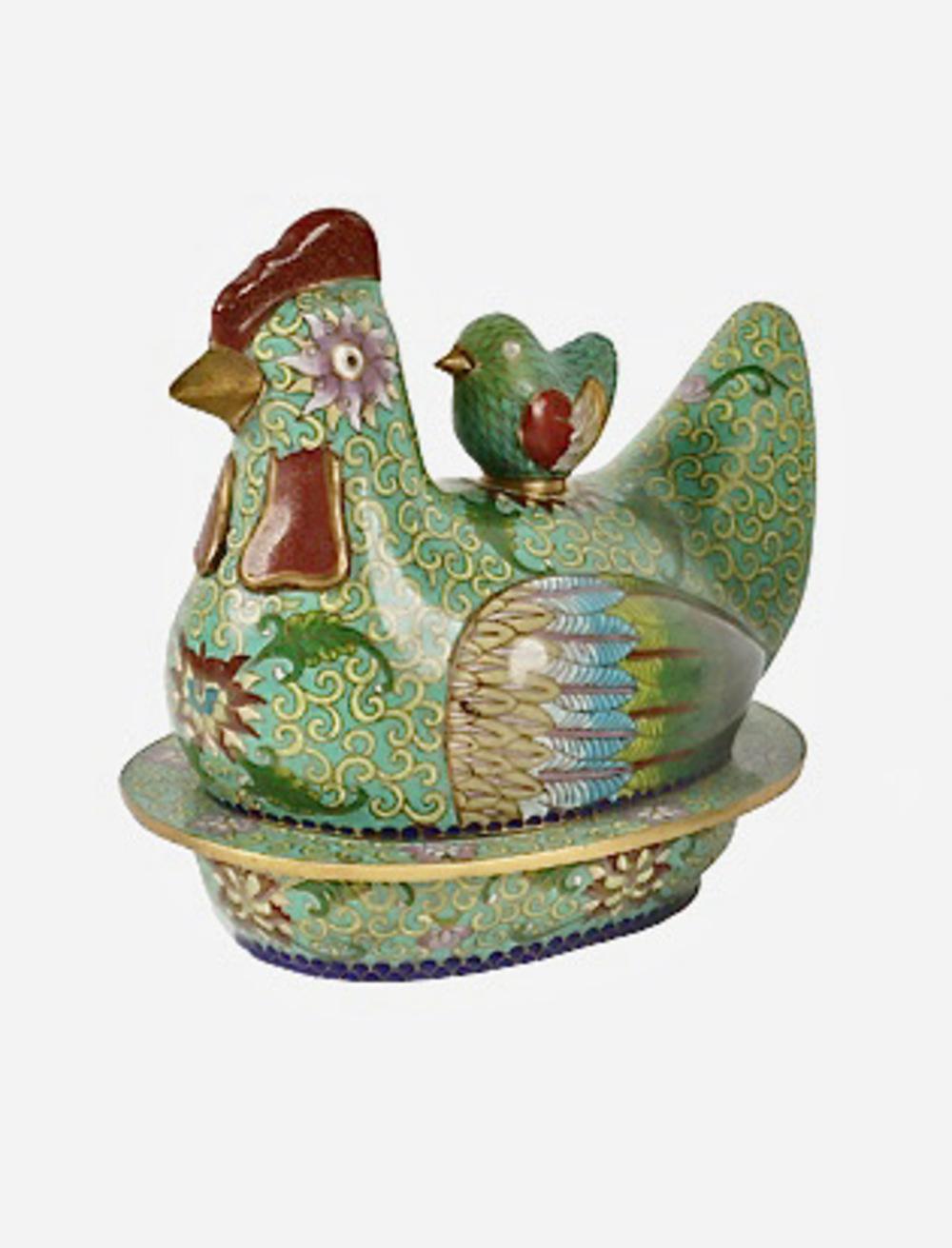 These are two very detailed cloisonne boxes in the form of nesting chickens. The principal color of one box is a pale green; the second box is a traditional Chinese turquoise. The lid of both boxes is detailed with a 