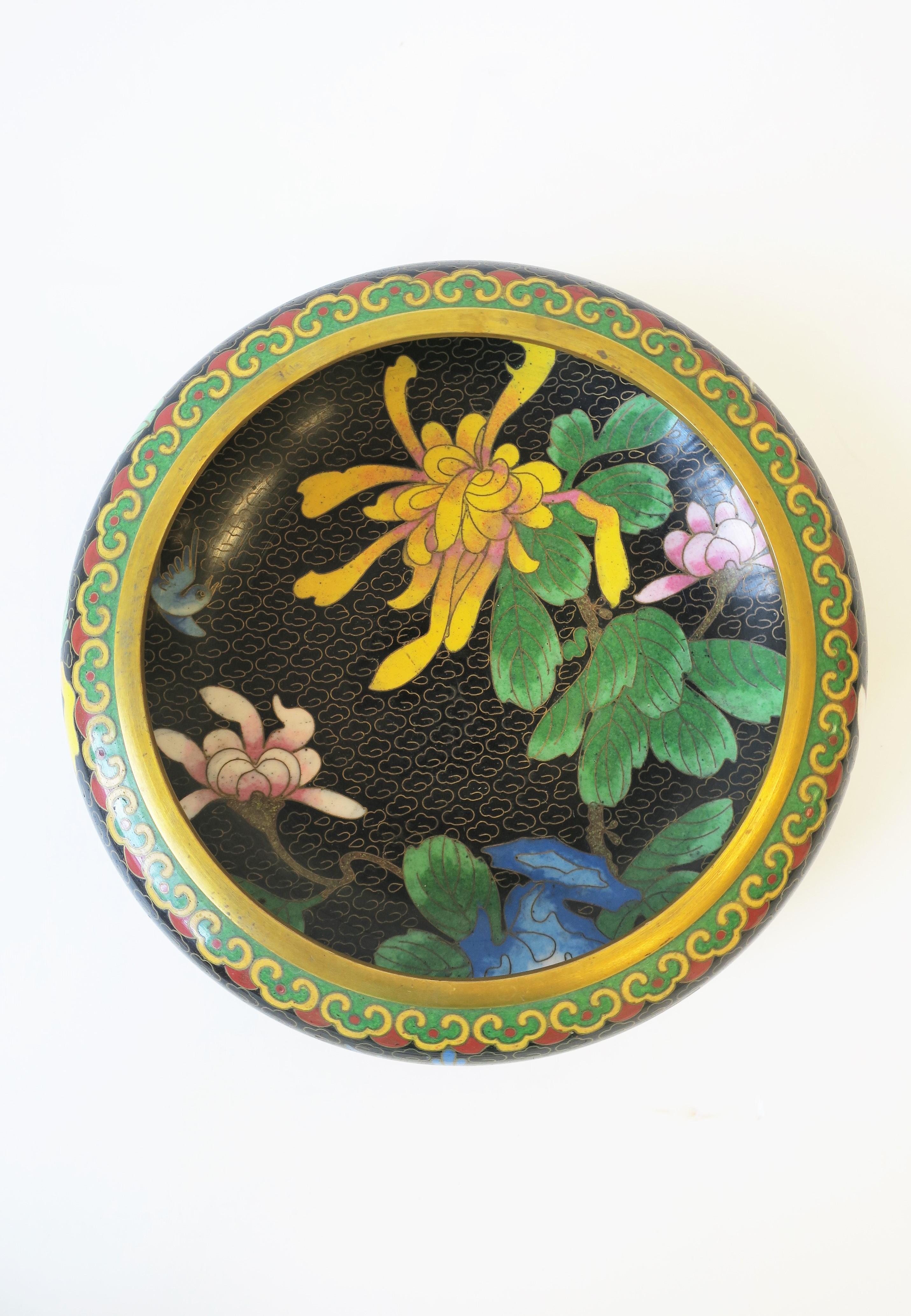A beautiful, striking, and colorful vintage cloisonné enamel and brass bowl with spider chrysanthemum flowers and bird design, circa 1960s, 1970s, Asia, China. Beautifully made brass metal and enamel work. Enamel bowl depicts flowers, leaves and