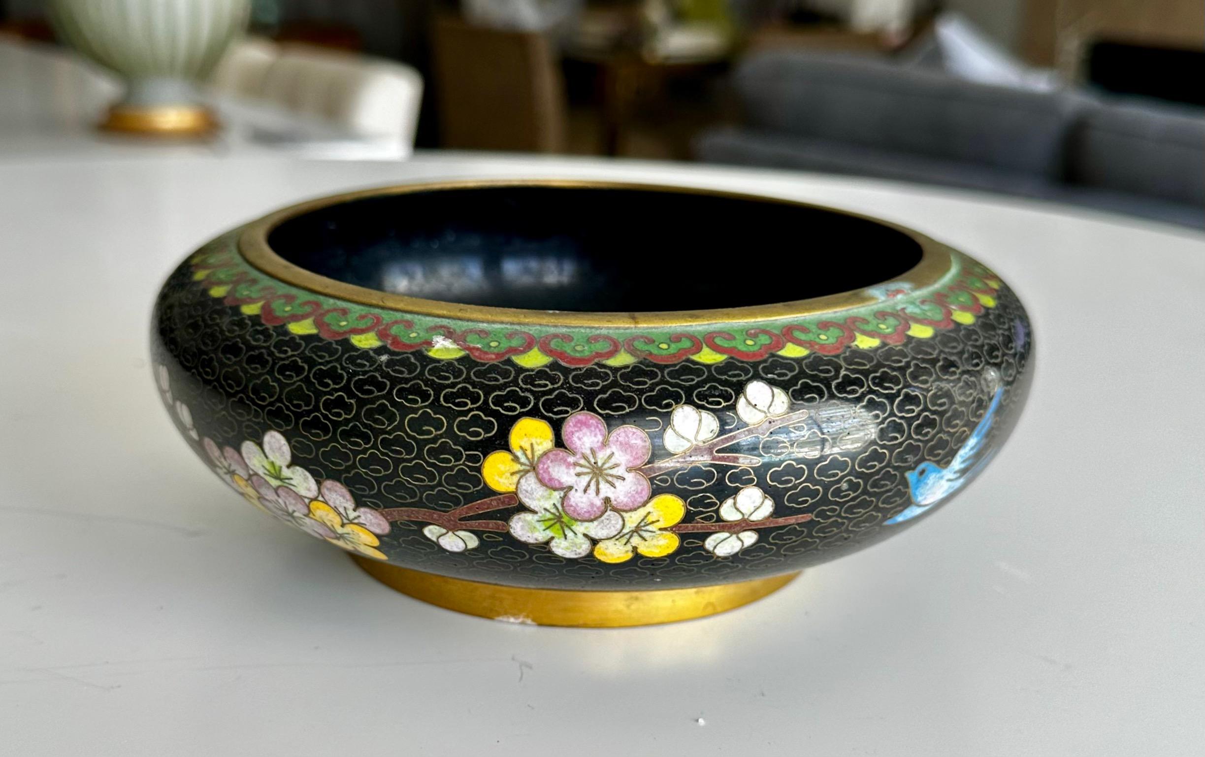 Chinese cloisonne enamel bowl embellished with pink and white flowers, geometric design and birds.