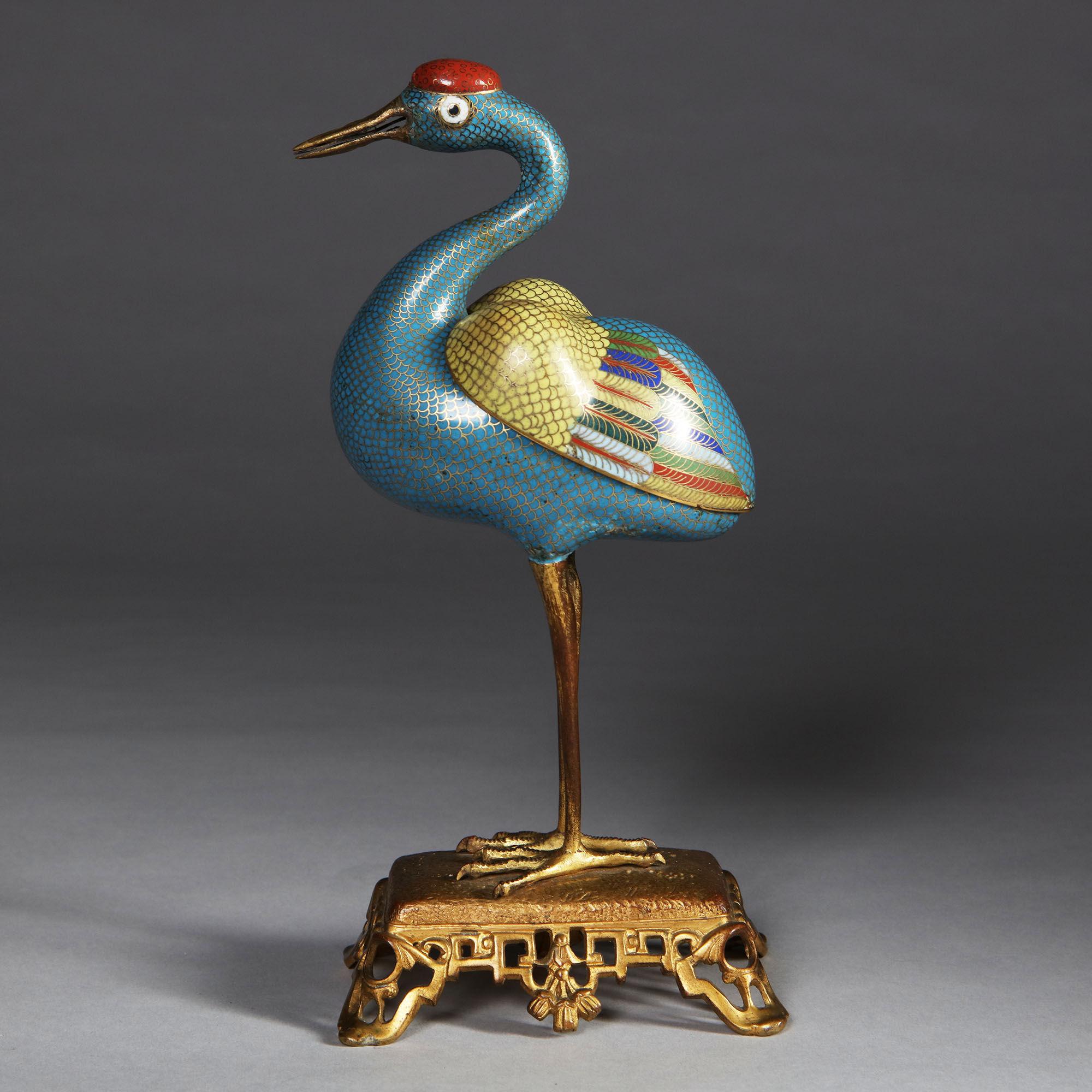 The characterful and charming 18th-19th century cloisonné enamel censer, is modelled as a crane with straight gilt-metal legs, realistically detailed feet and claws, standing on a detailed gilt base. The neck gracefully curved above the plump hollow